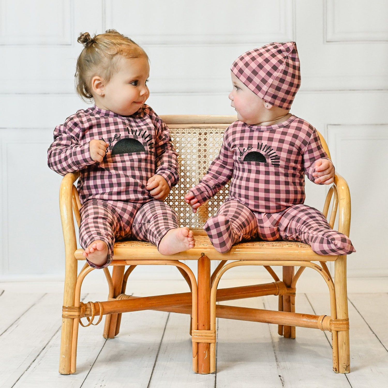 Happy toddler in cozy pajamas smiling on the couch, perfect for sweet dreams and stylish sleepwear.