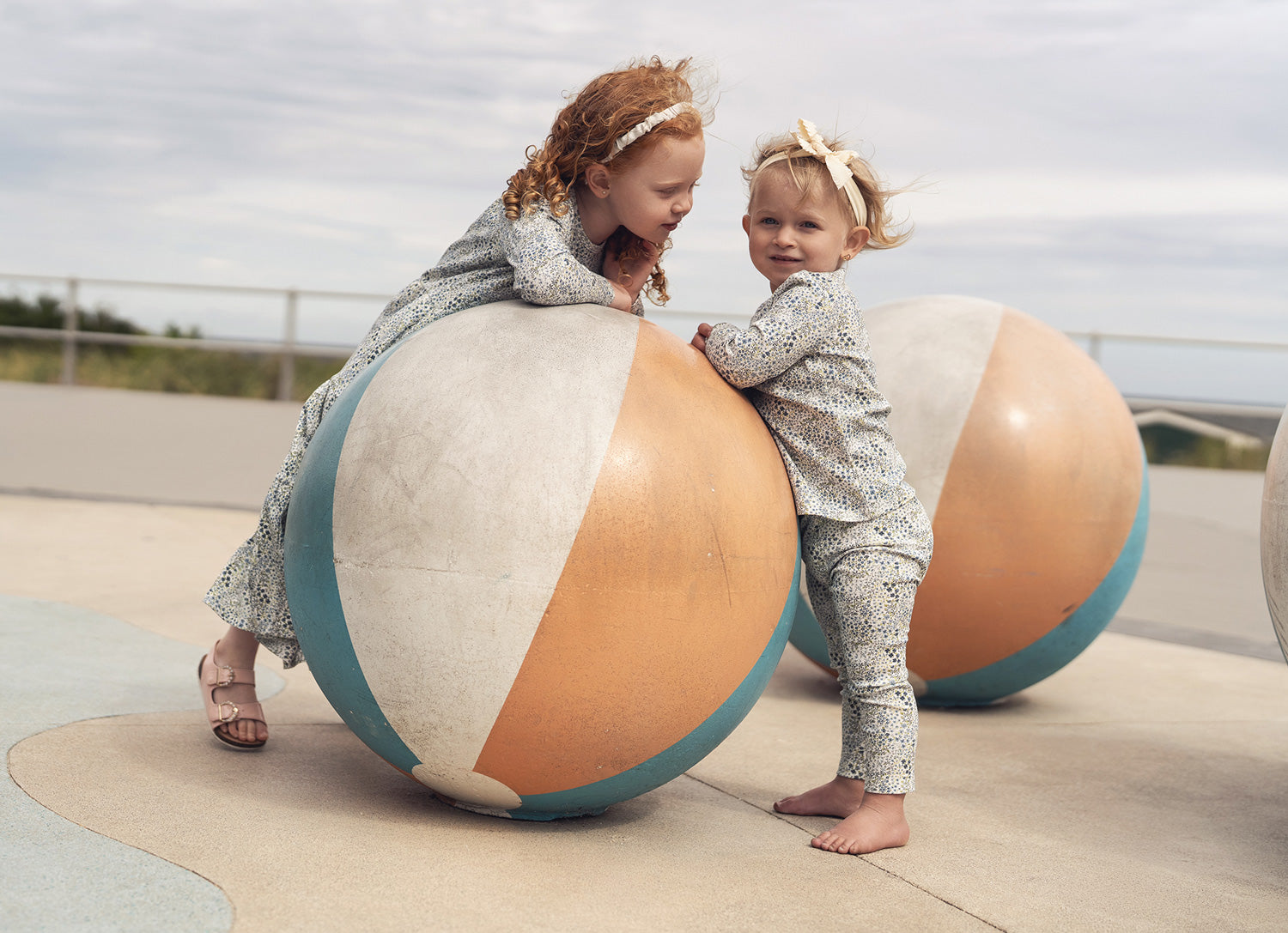 Happy toddler in cozy pajamas smiling on the couch, perfect for sweet dreams and stylish sleepwear.