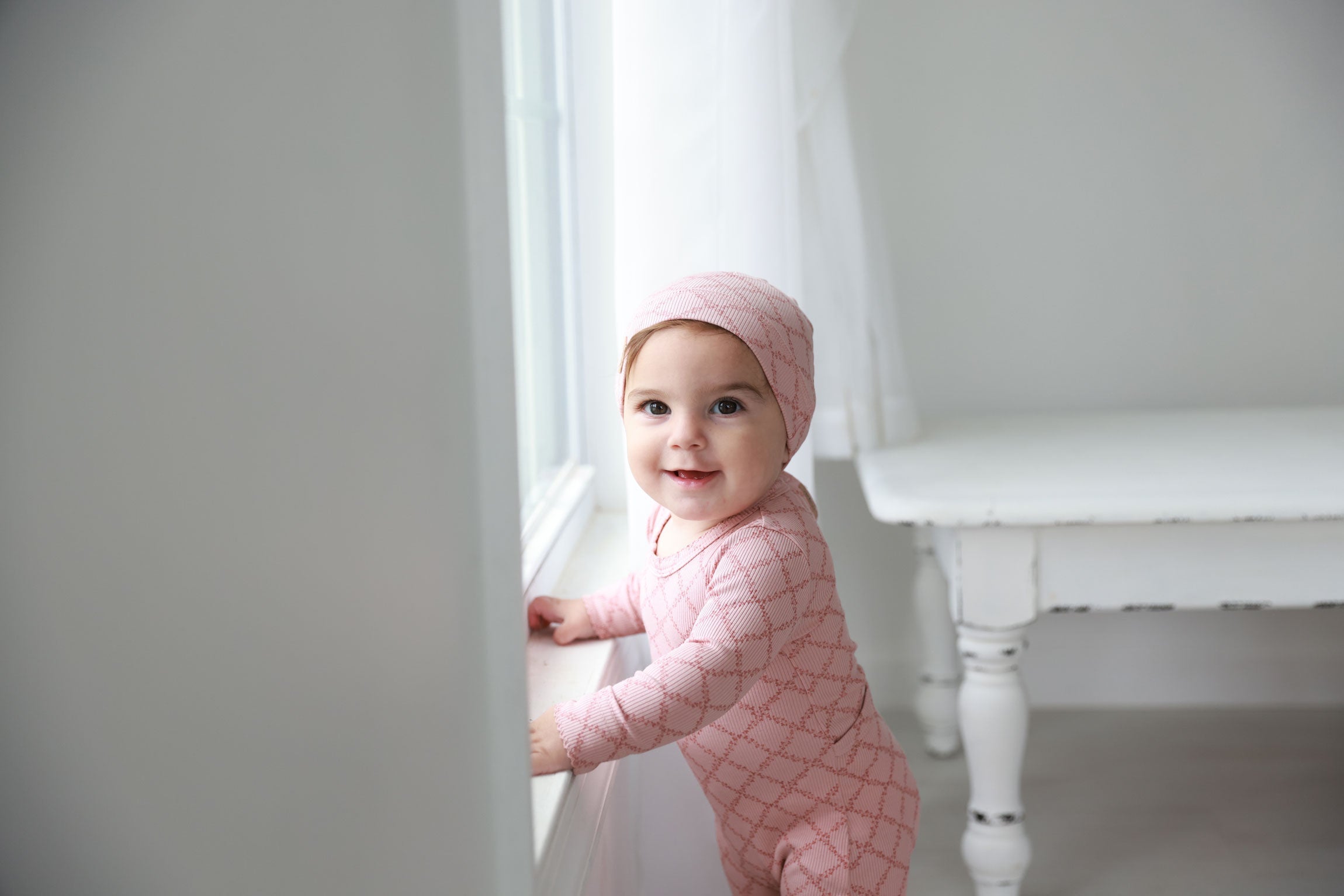 Infant wearing a floral baby beanie hat, showcasing style and warmth for colder weather.