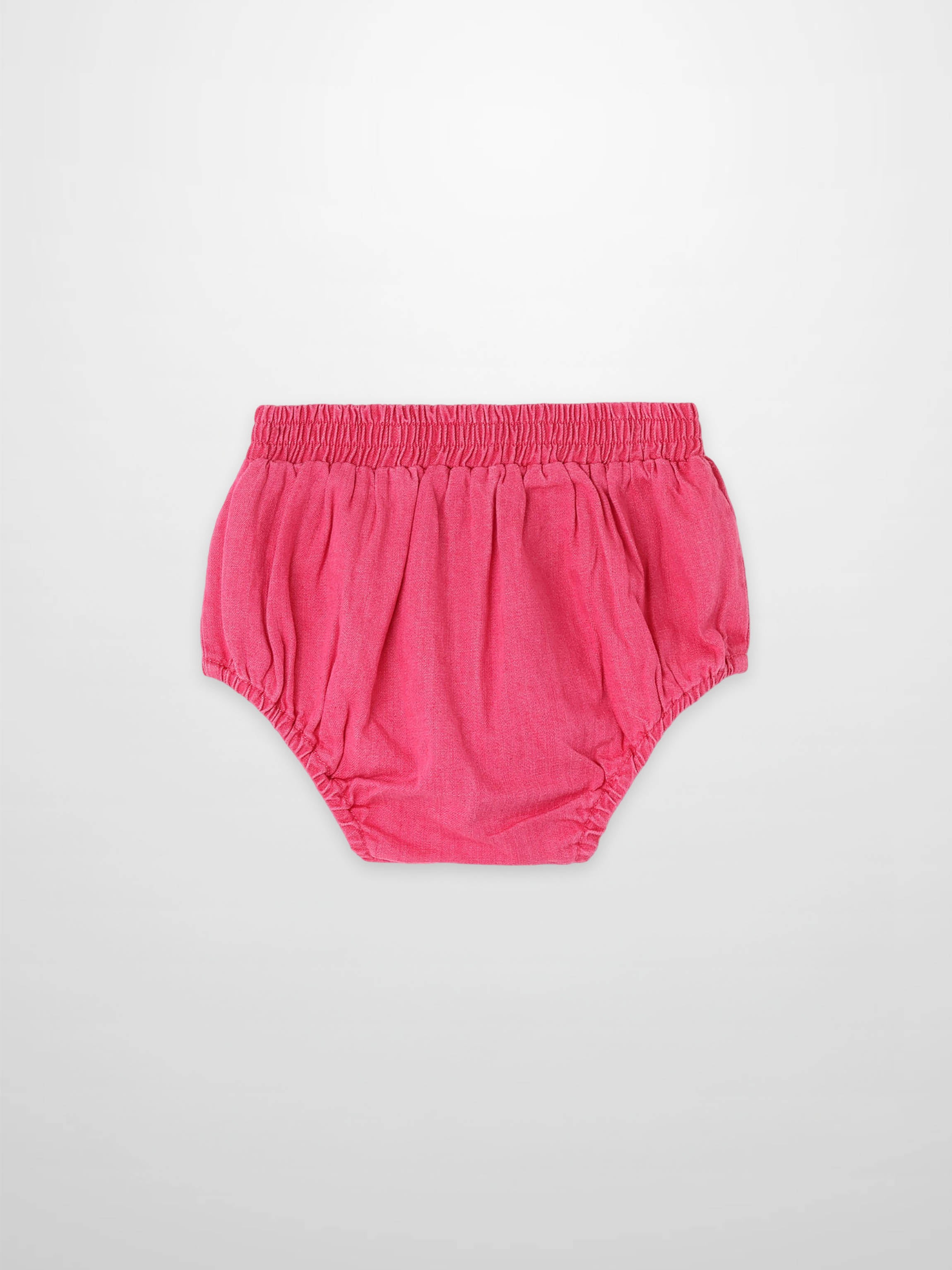 Paneled Bloomers in pink denim with elastic waistband and gathered leg openings.
