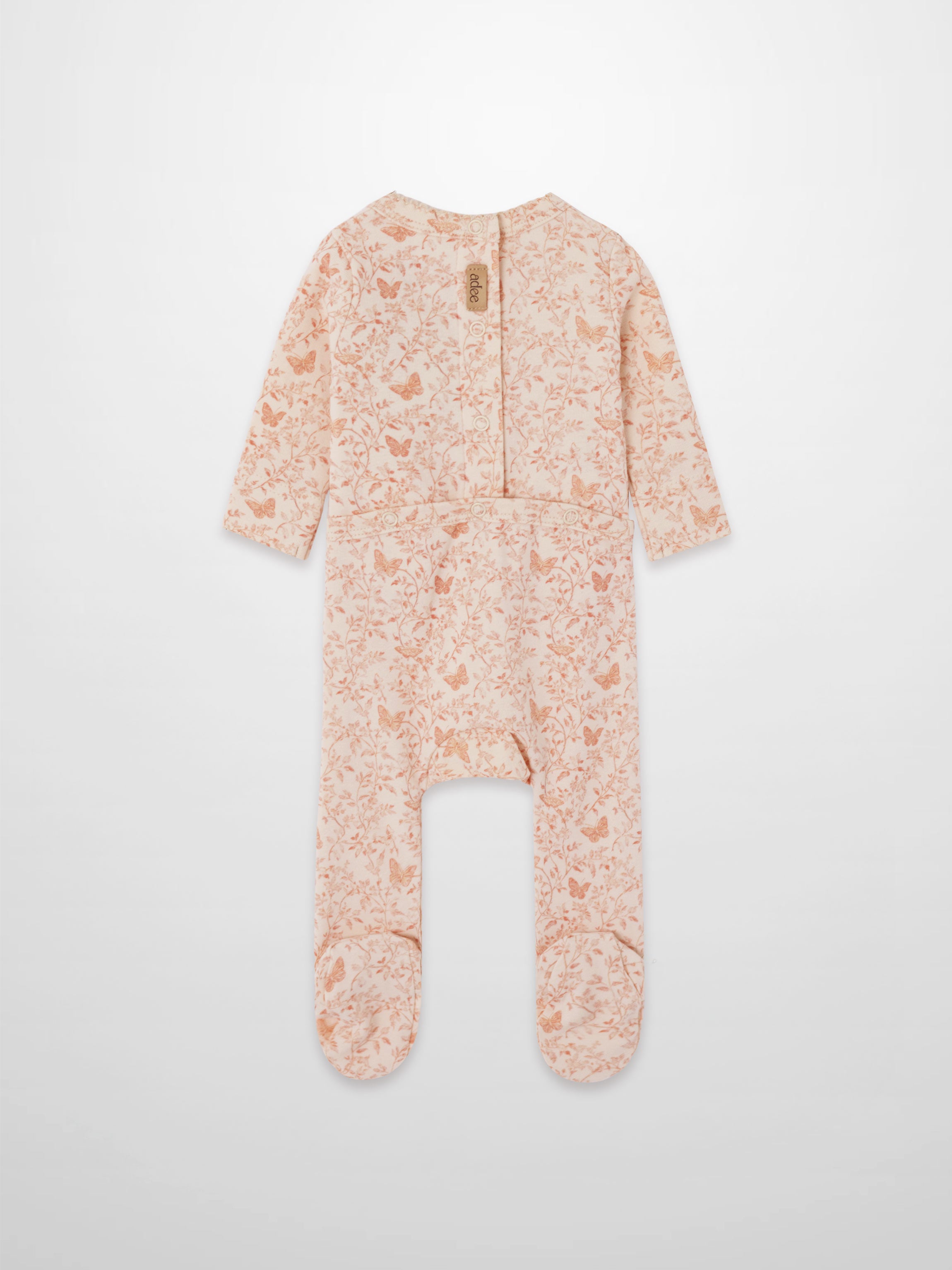 light pink printed garden stretchy on a baby jumpsuit footie with snaps on back