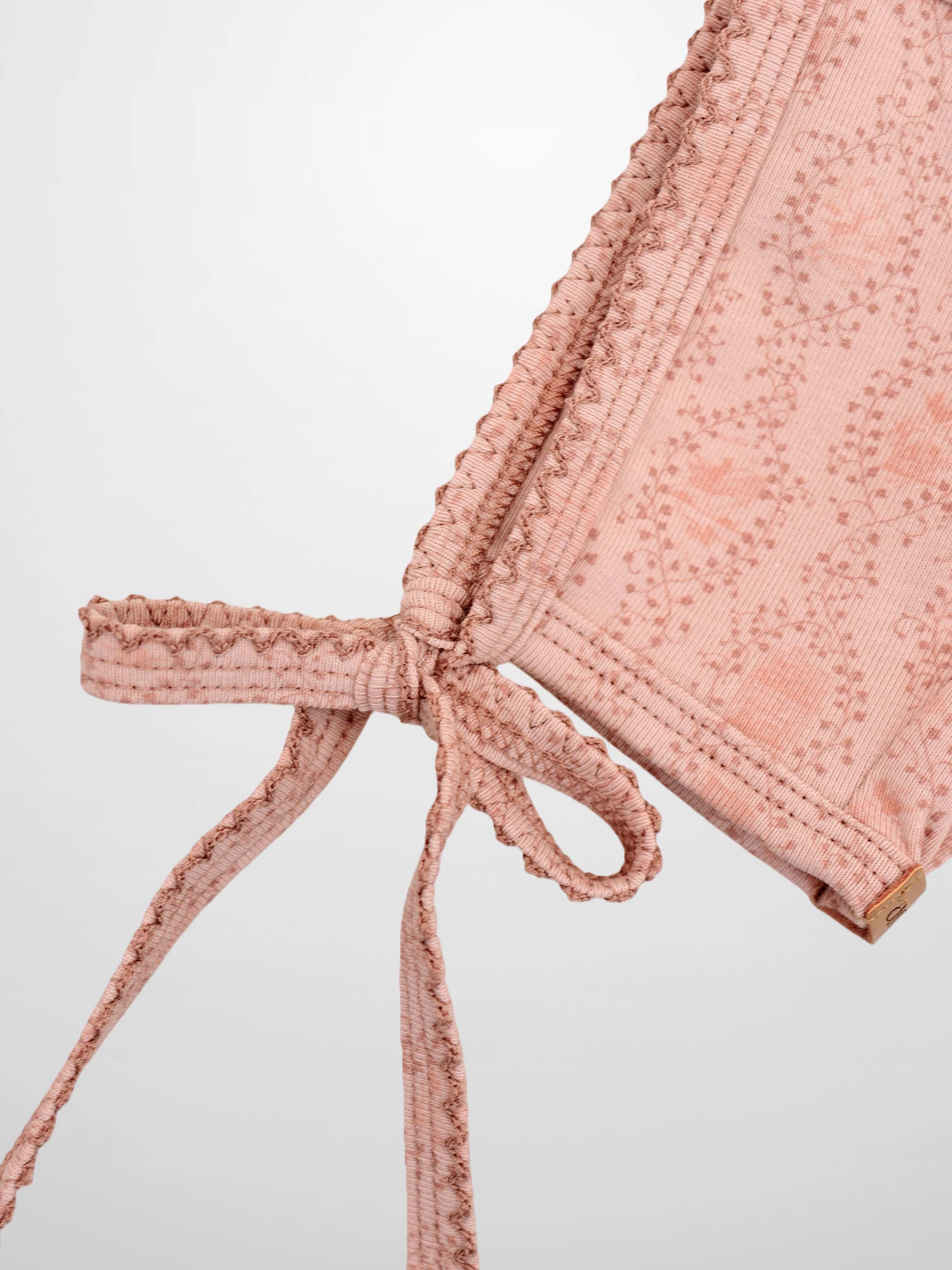 Pink Charm Bonnet for girls by Adee, pink vine-patterned fabric with tie strings.