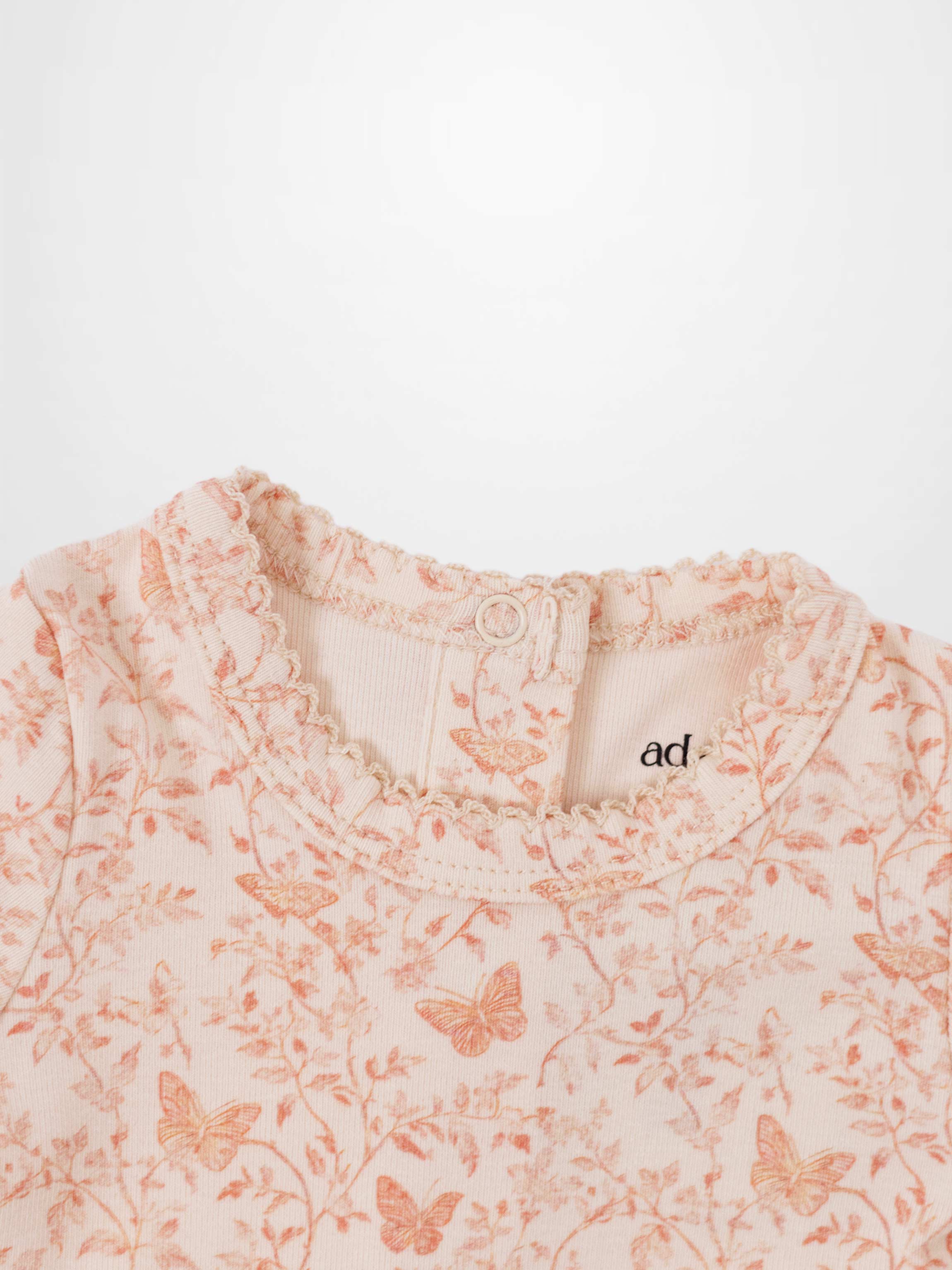 snap in back of light pink baby jumpsuit adee