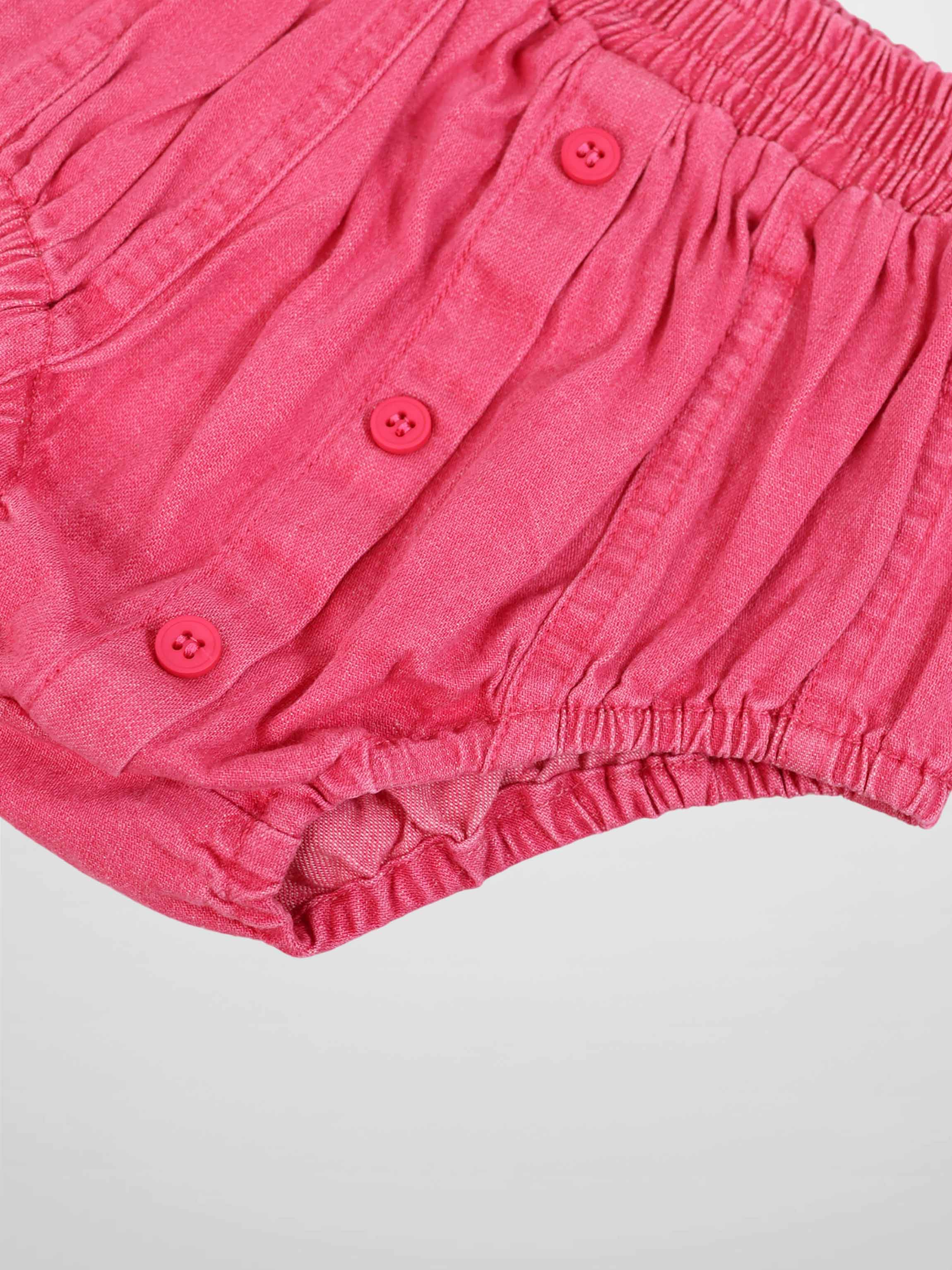 Paneled pink denim bloomers with a button-front placket and elasticized leg openings.