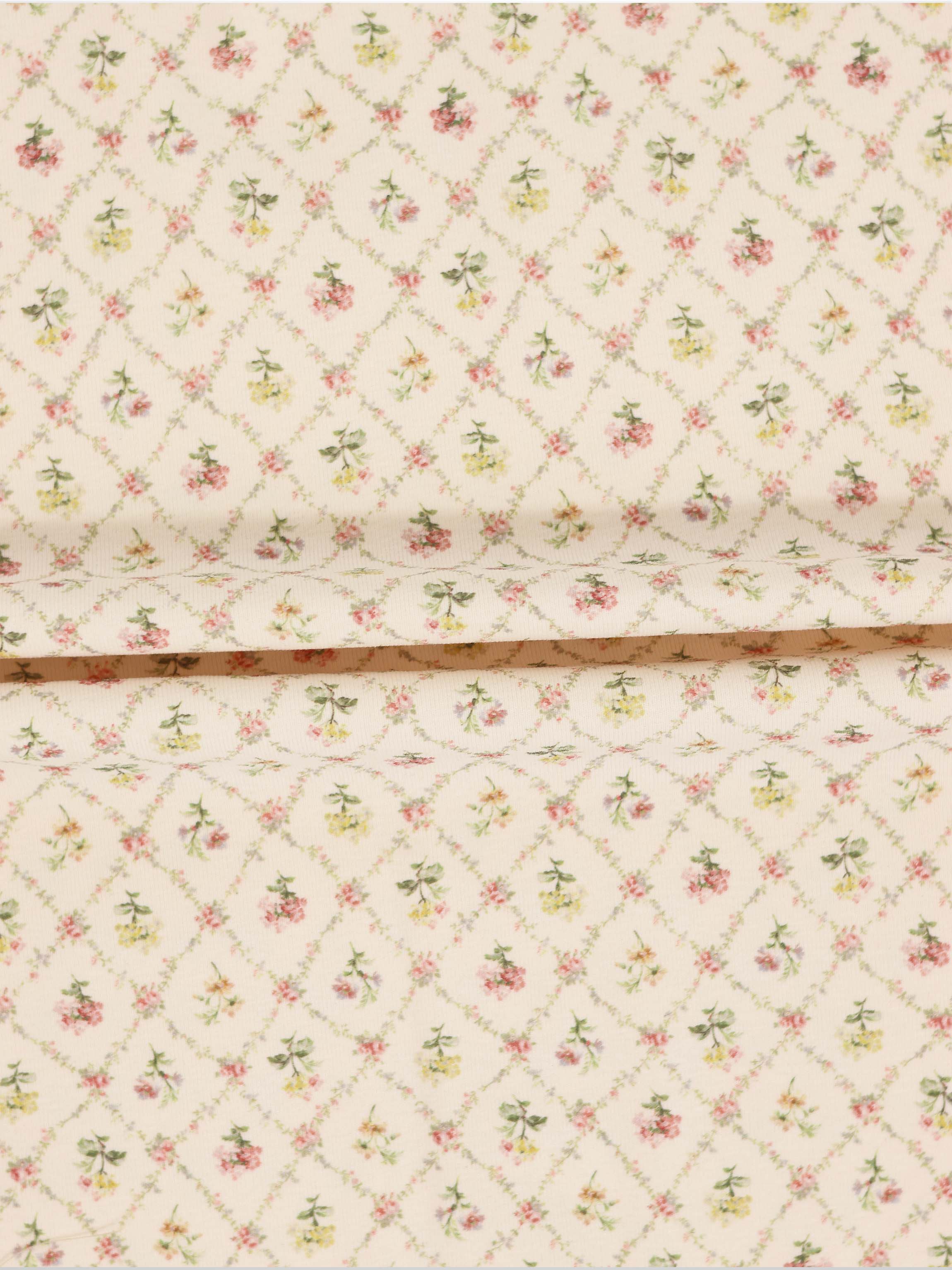 Flower Garden Stretchy girls stretchies fabric with a lattice-diamond floral pattern in pink, yellow and green on beige