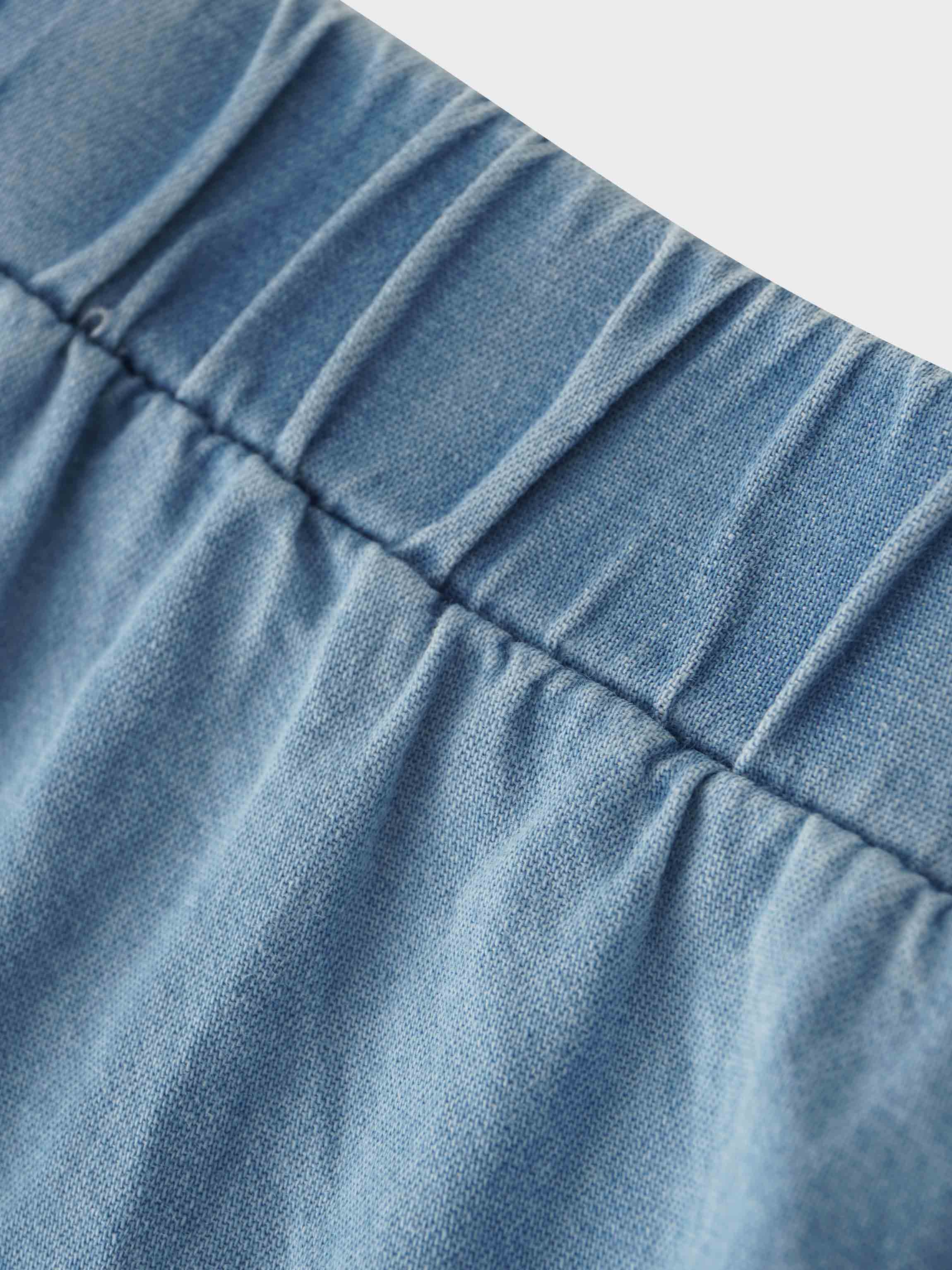 elastic waistband on a light denim skirt for girls