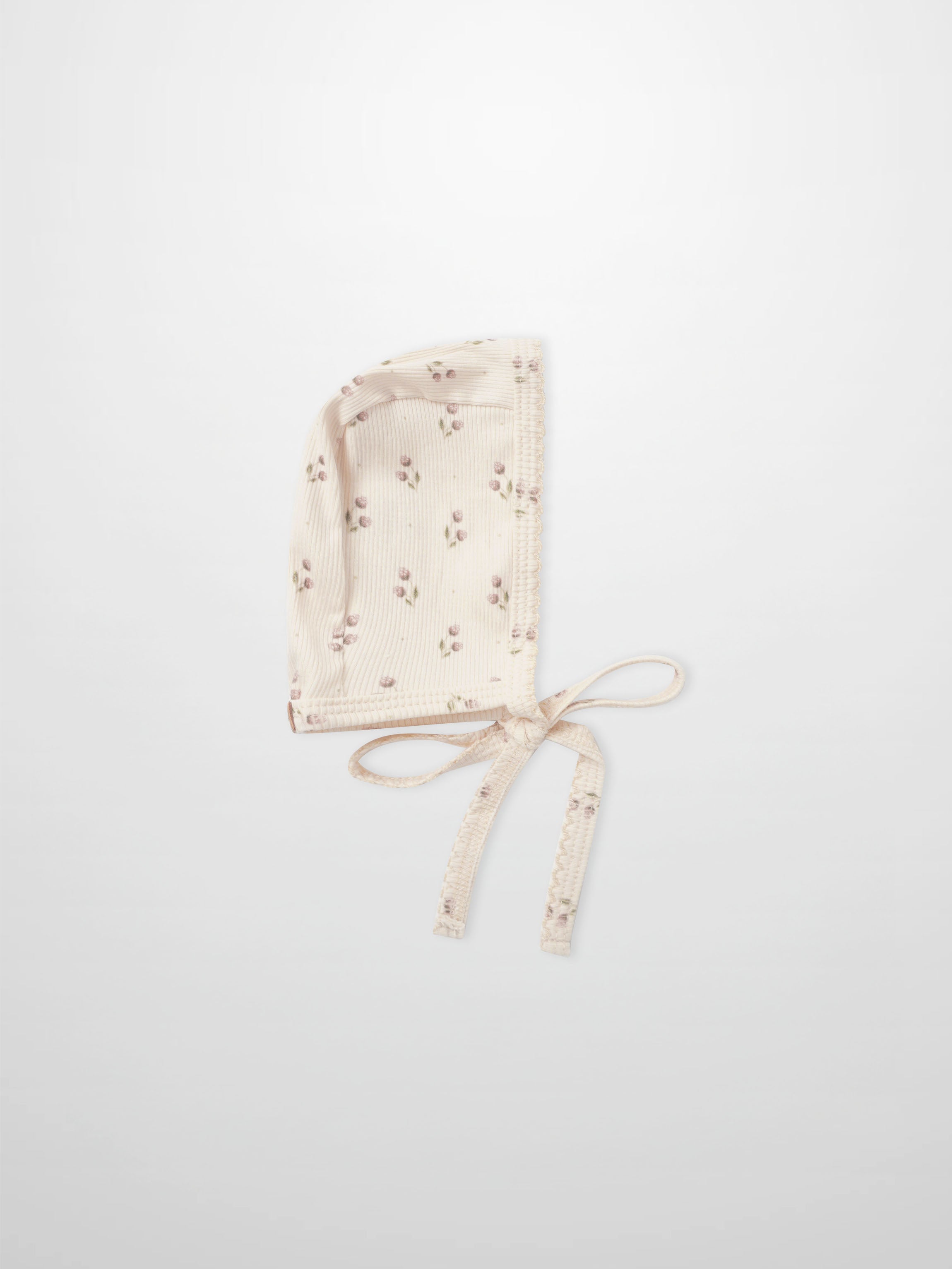 Tiny Tulip Bonnet in cream ribbed fabric with pink floral print and tie strings