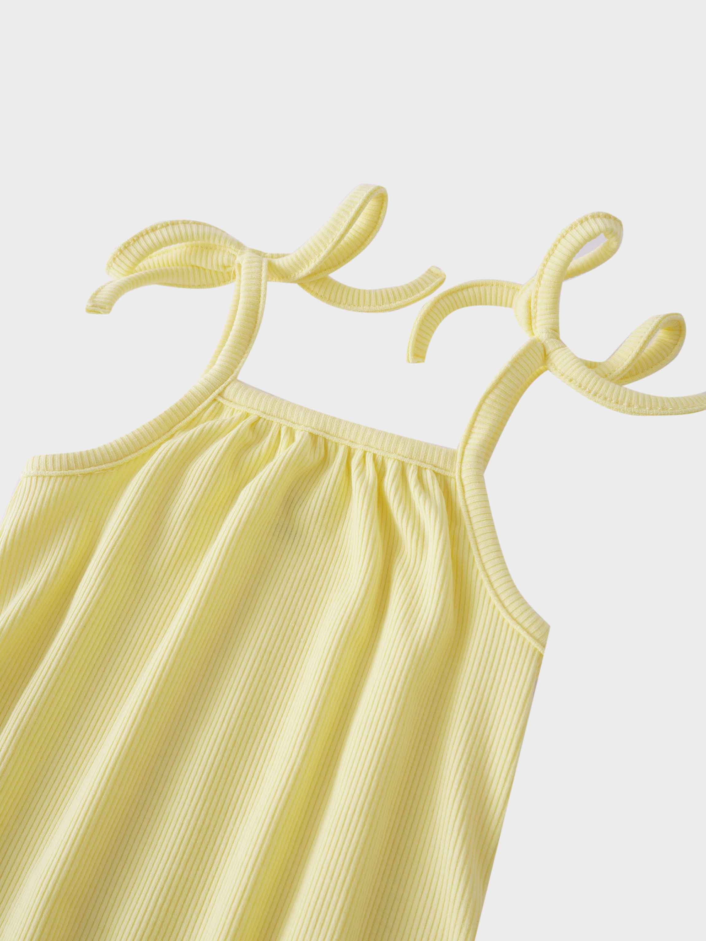Yellow romper with playful bows