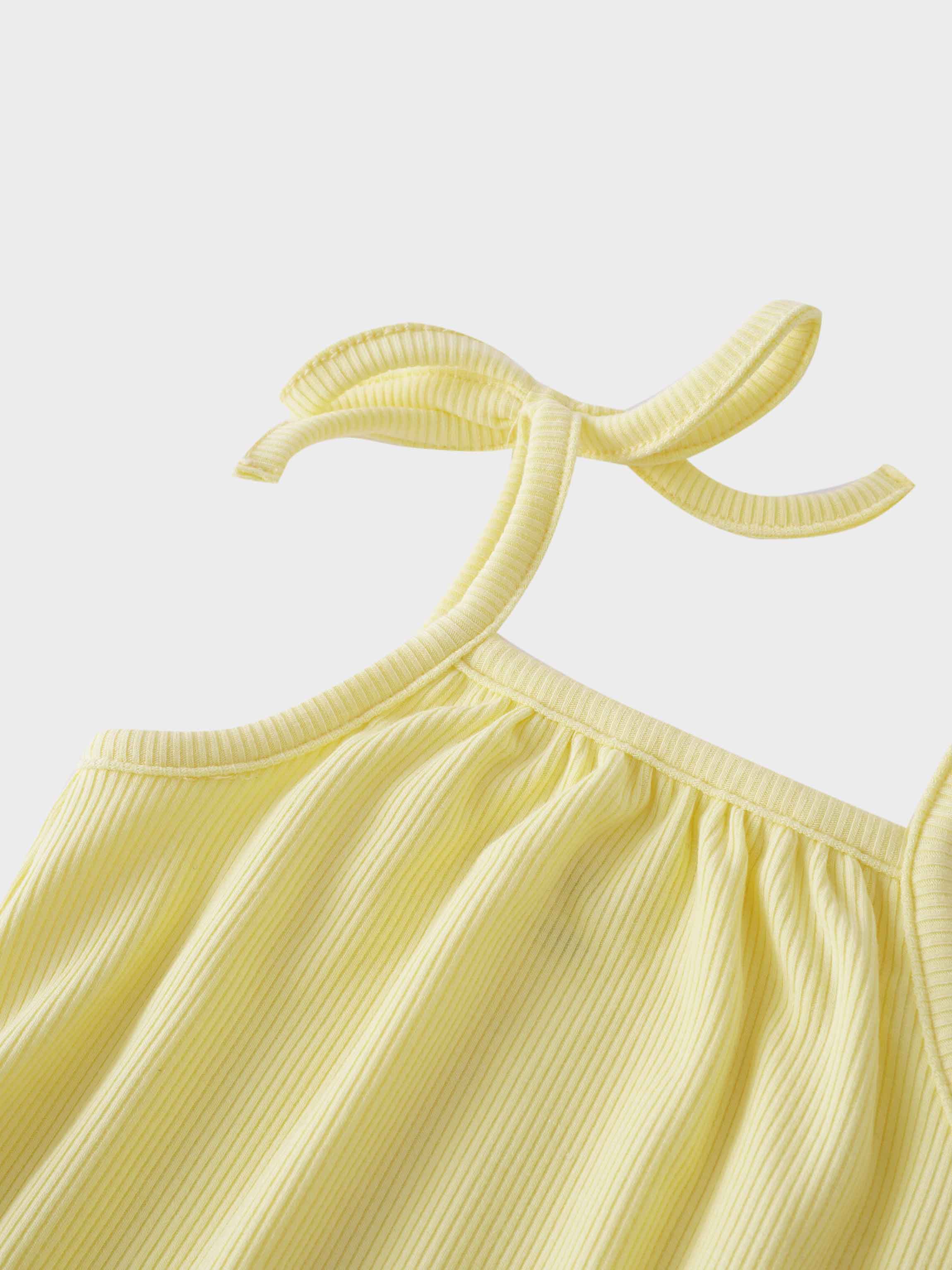 Yellow romper with playful bows