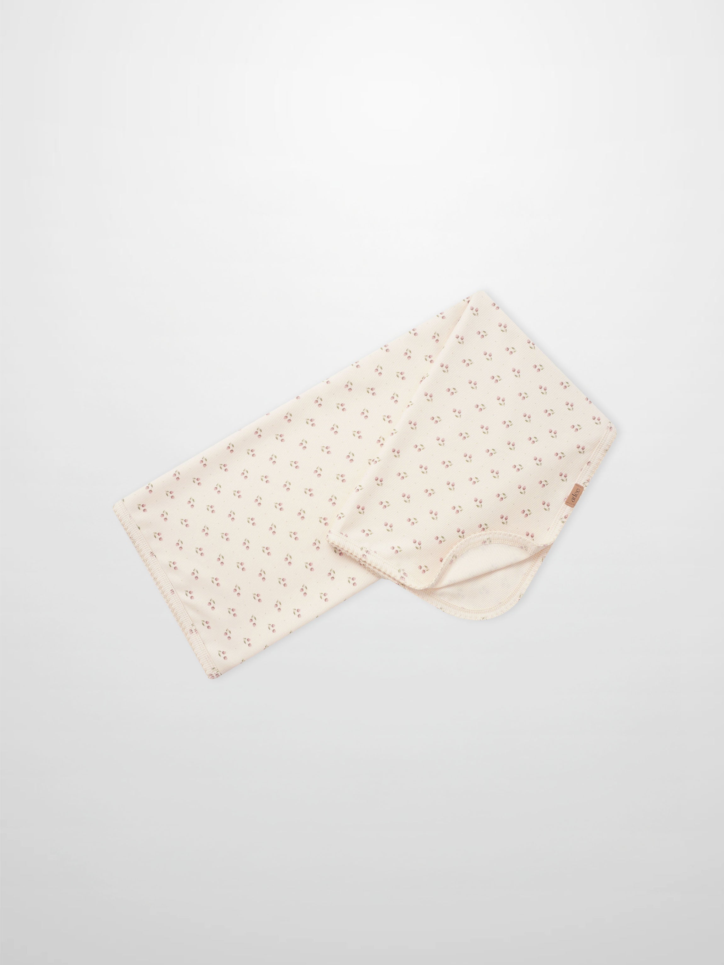 Tiny Tulip Blanket by Adee; cream girls swaddle blanket with tiny pink tulip floral pattern.