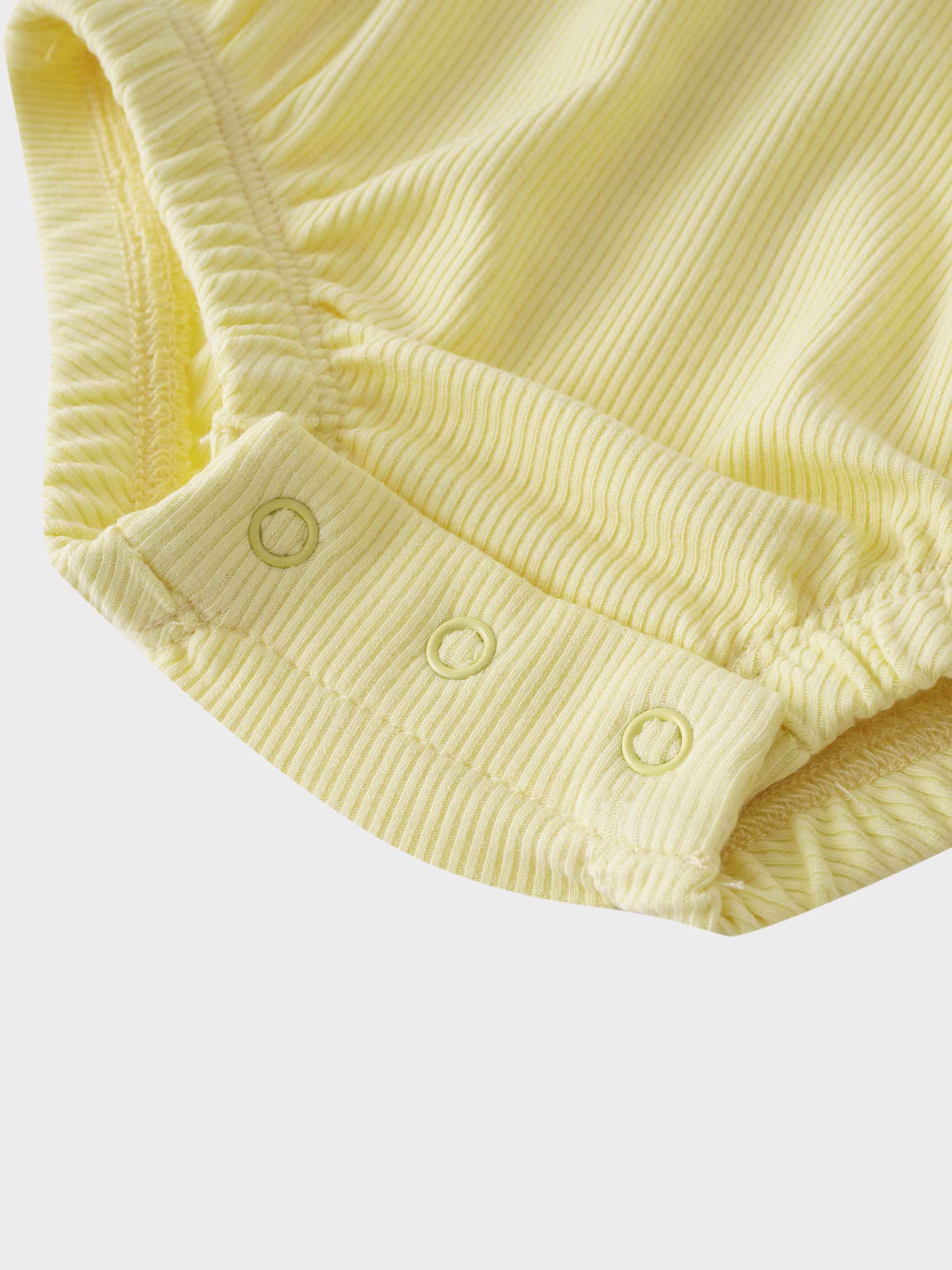 Yellow baby romper bottom view