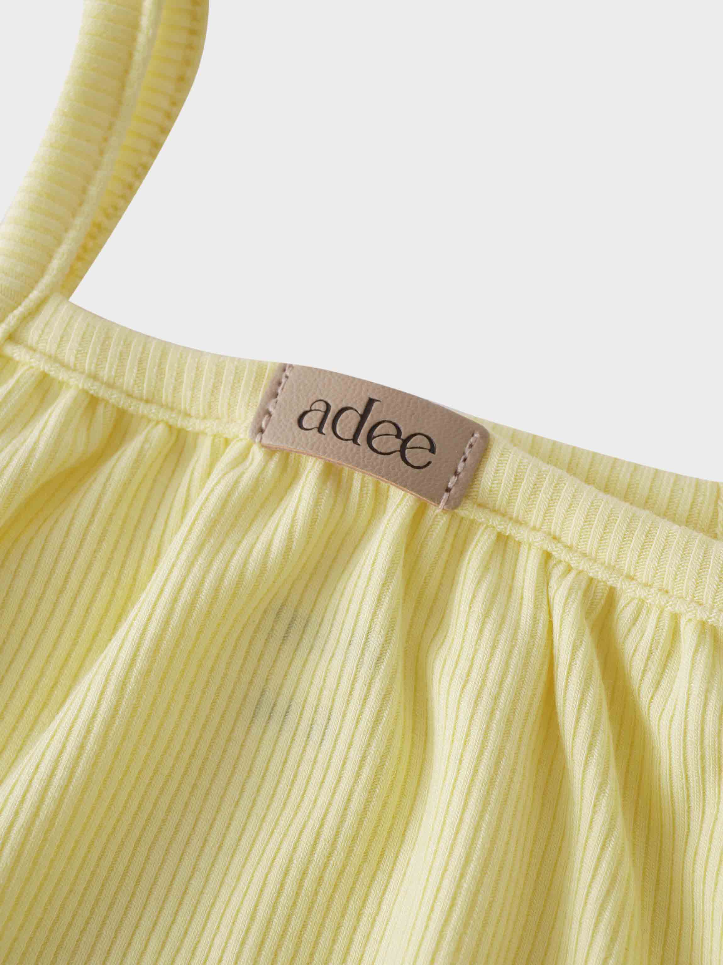 Yellow romper shoulder straps detail