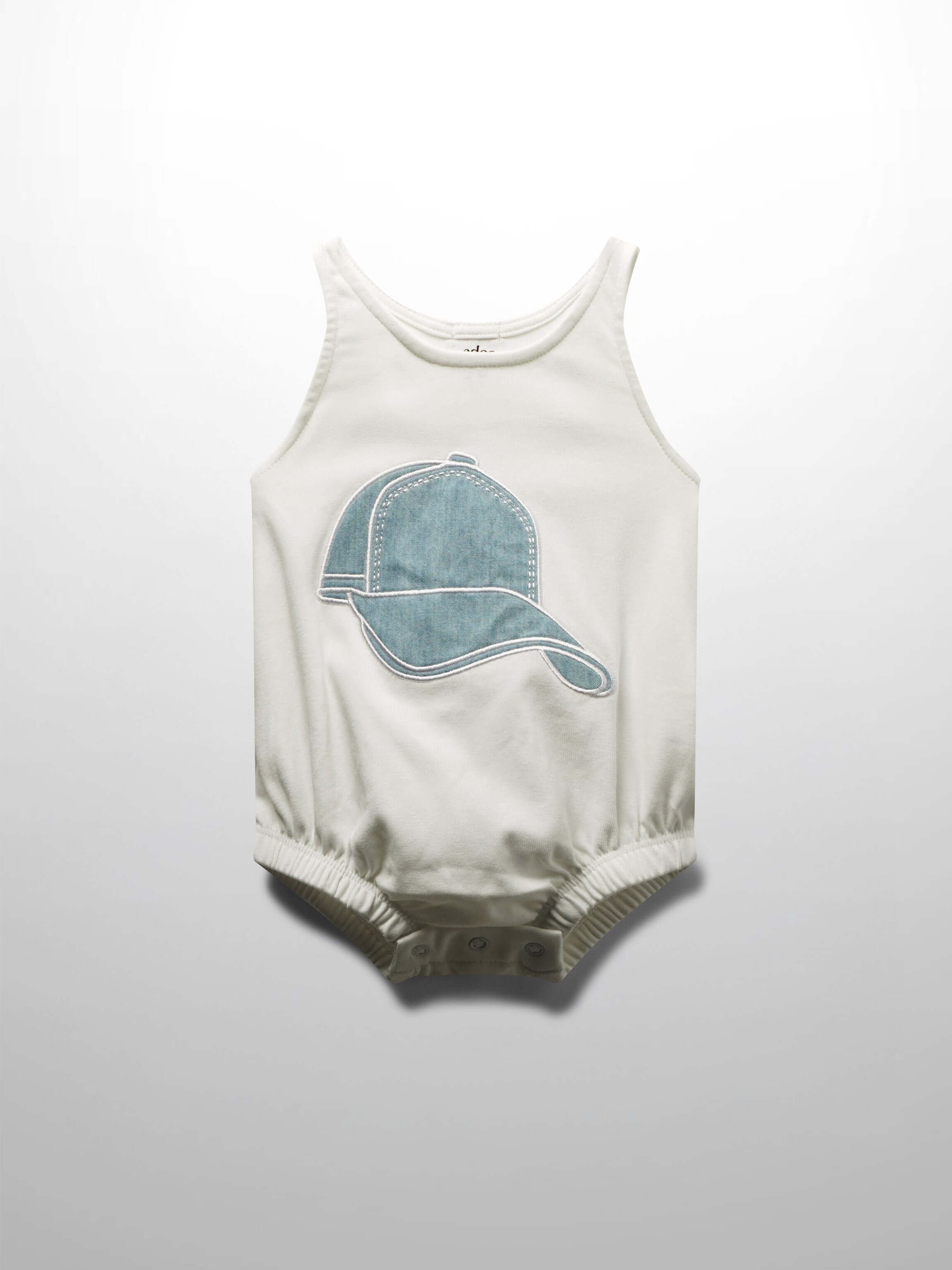 White baby romper with baseball cap