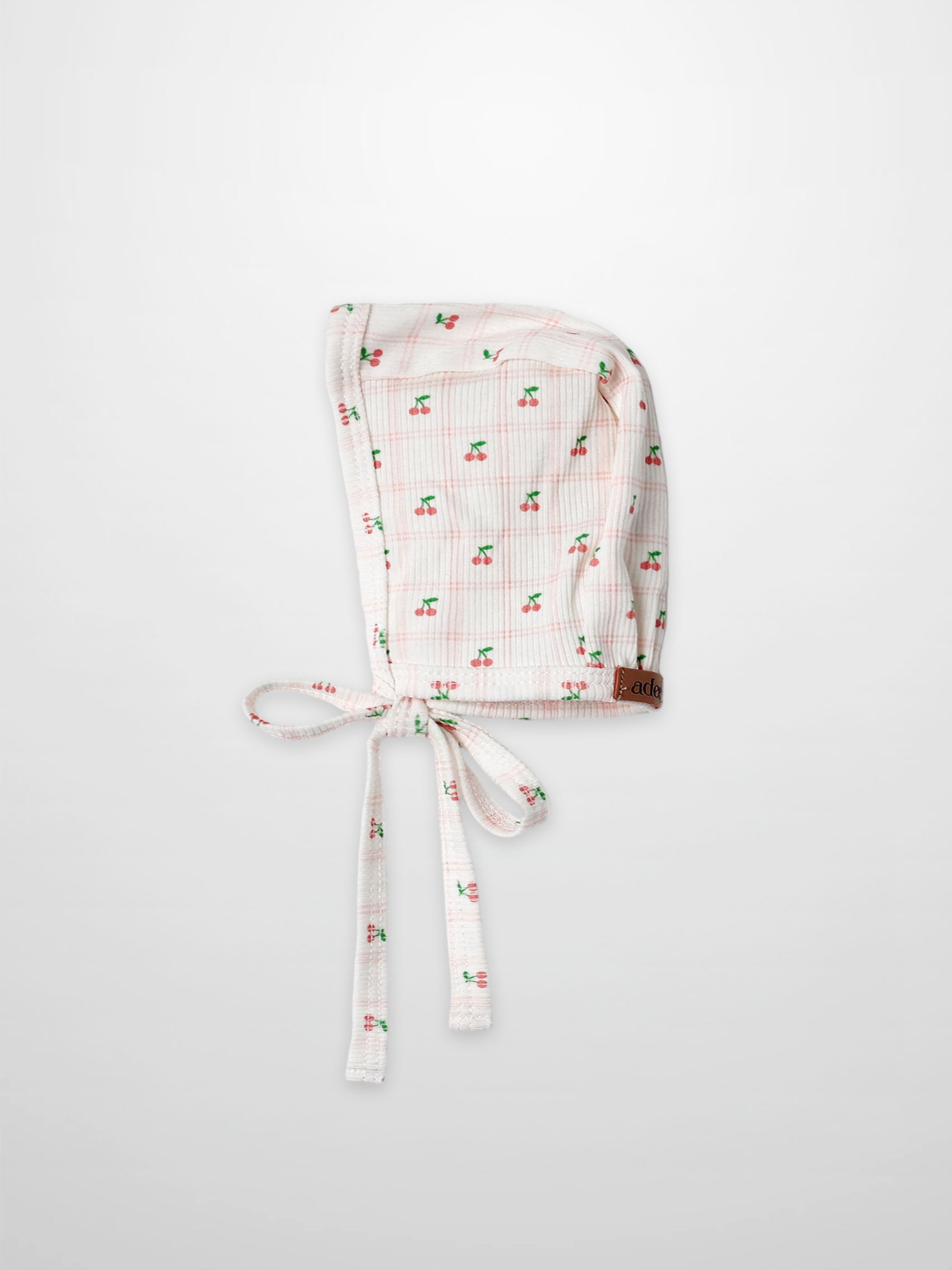 Adee Cherry Window Bonnet for girls, soft thin-ribbed fabric with pink cherry print and tie strings.