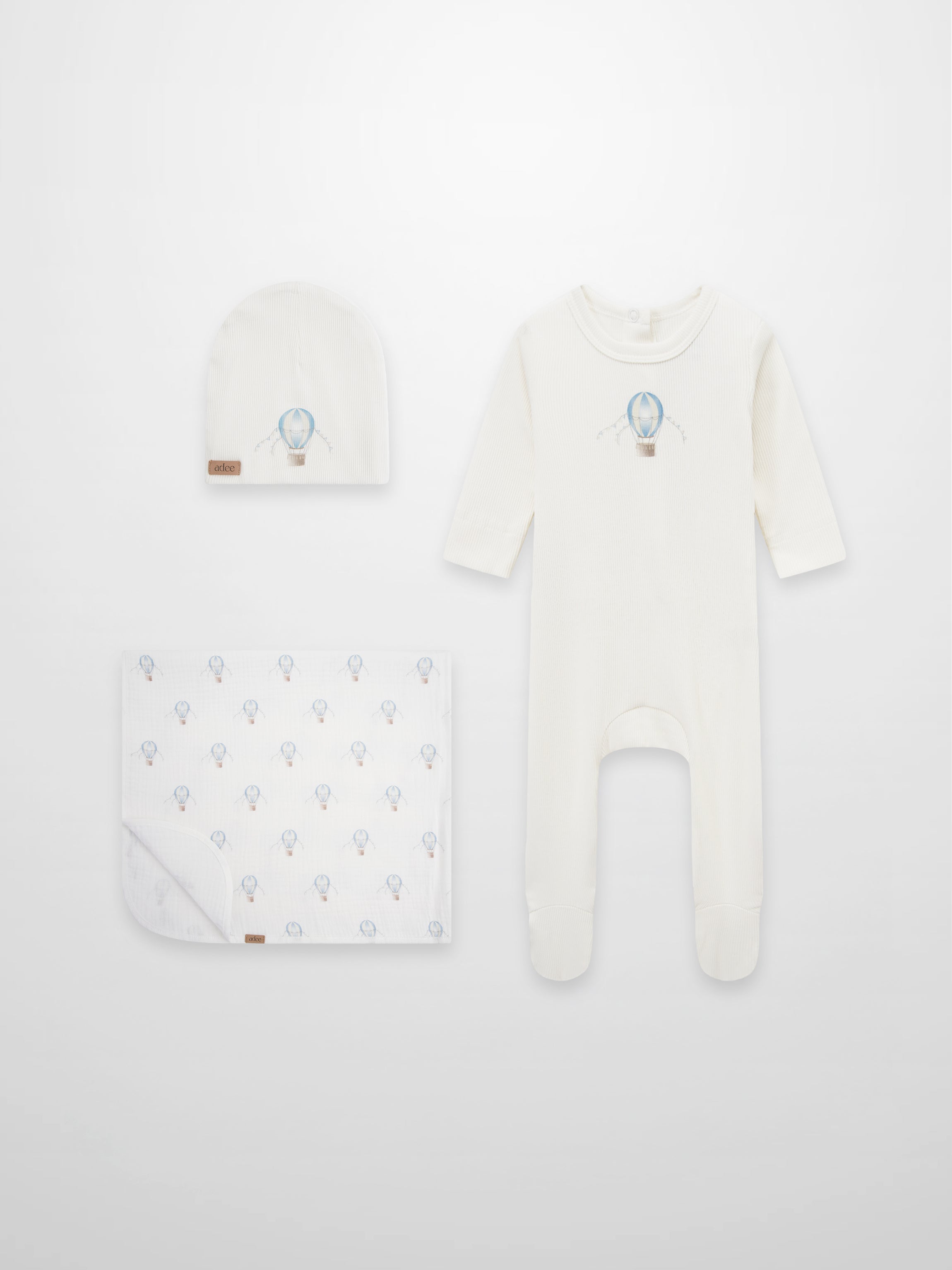 Adee Blue Balloon layette set: cream romper with blue balloon motif, matching hat and patterned blanket
