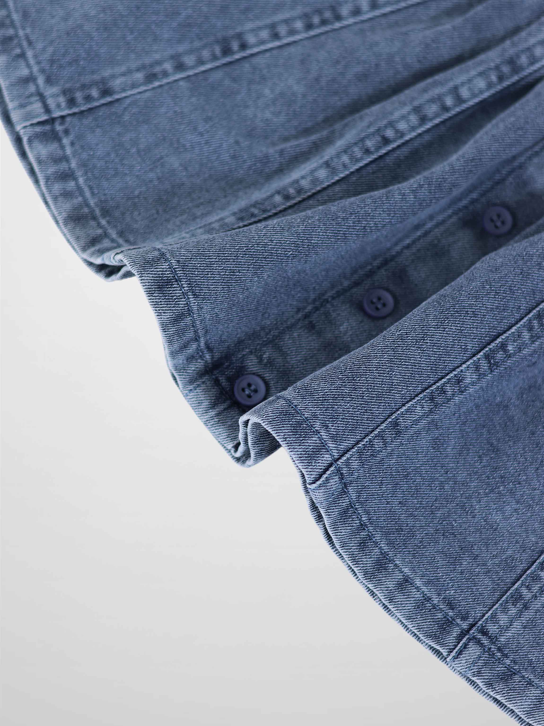 Paneled Skirt - Blue Denim; close-up of blue denim fabric with navy buttons