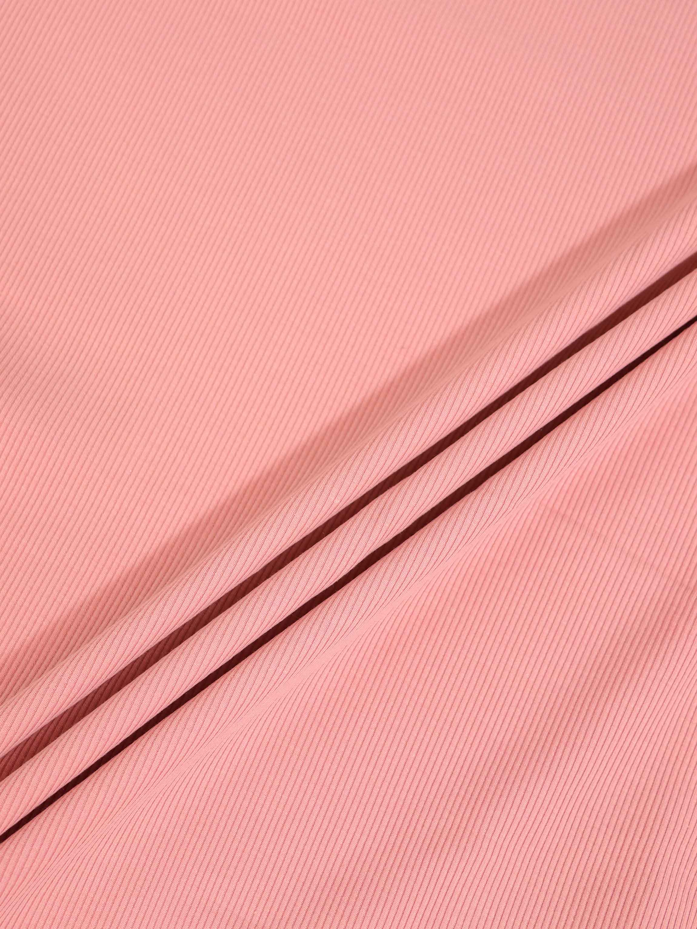 Thin ribbed beanie for girls in light pink; knit fabric close-up