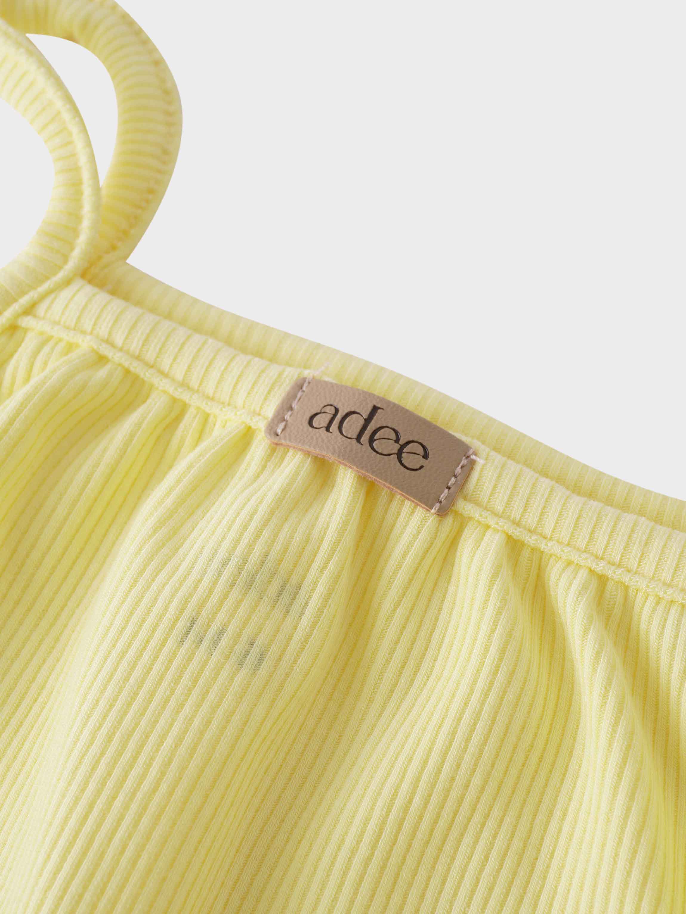 Close-up of yellow ribbed romper