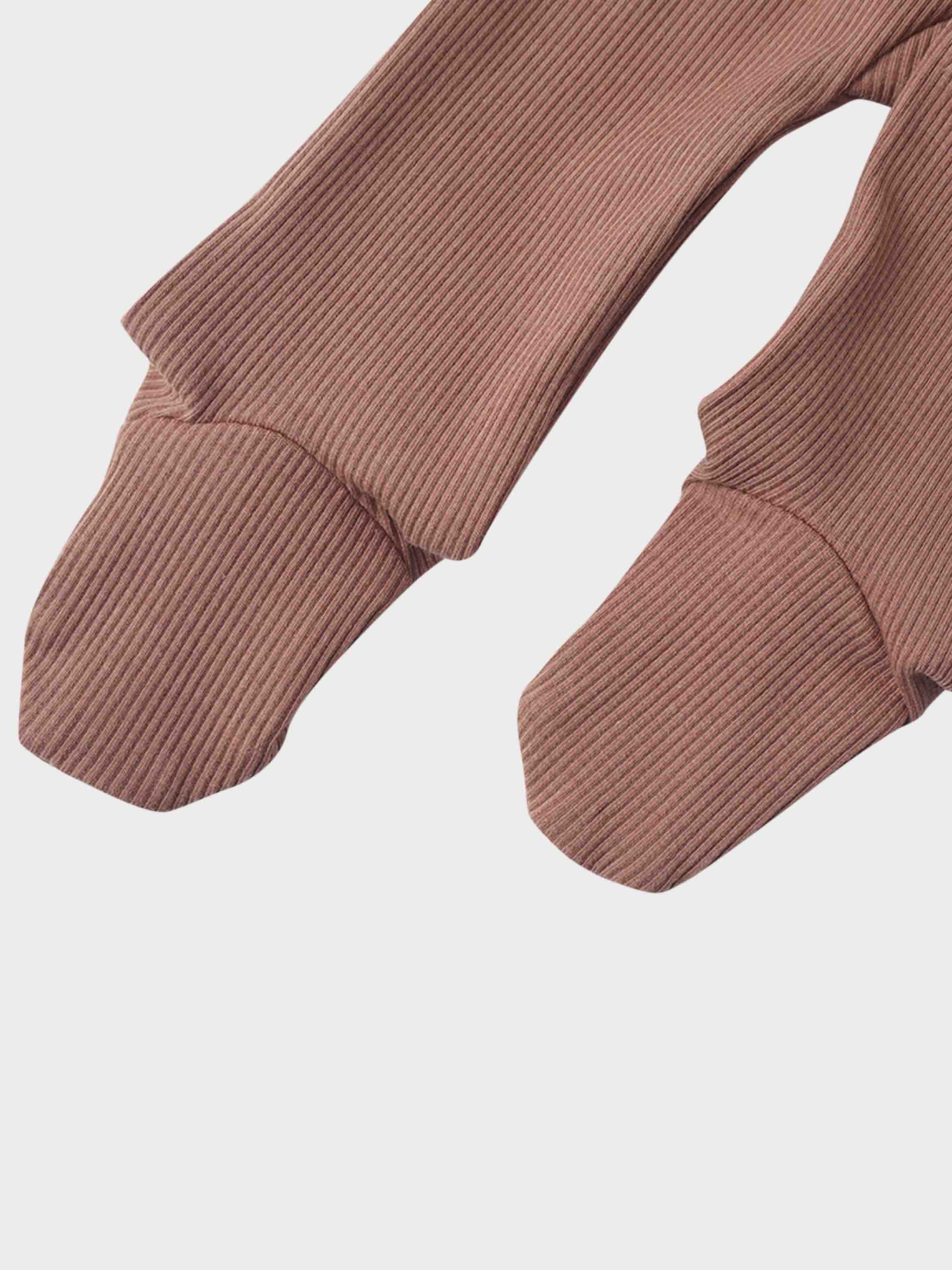 Pink ribbed fabric sleeves with snug cuffs.