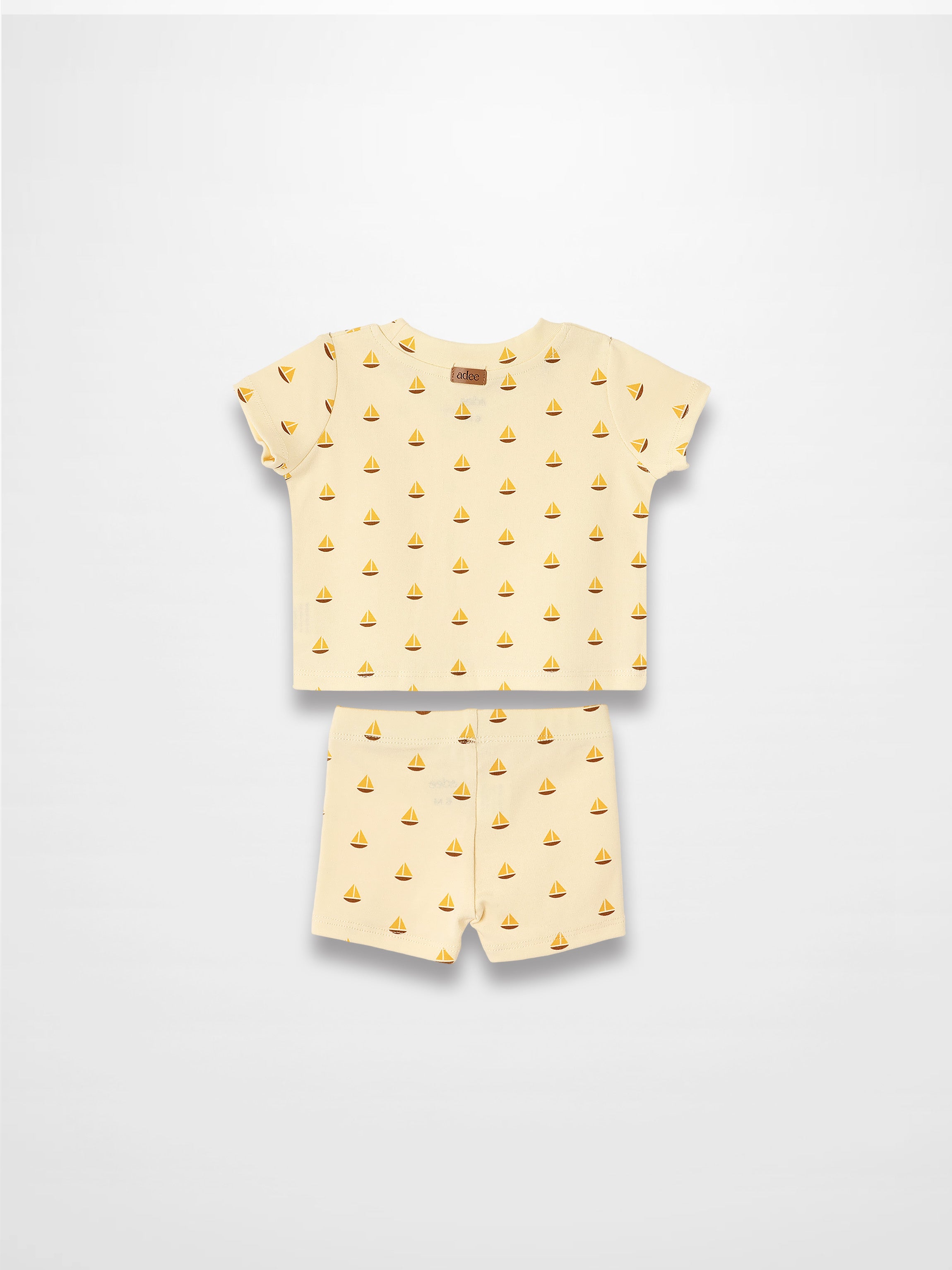 Adee Boat Print two-piece set for little boys with cream-yellow short-sleeve tee and matching shorts.