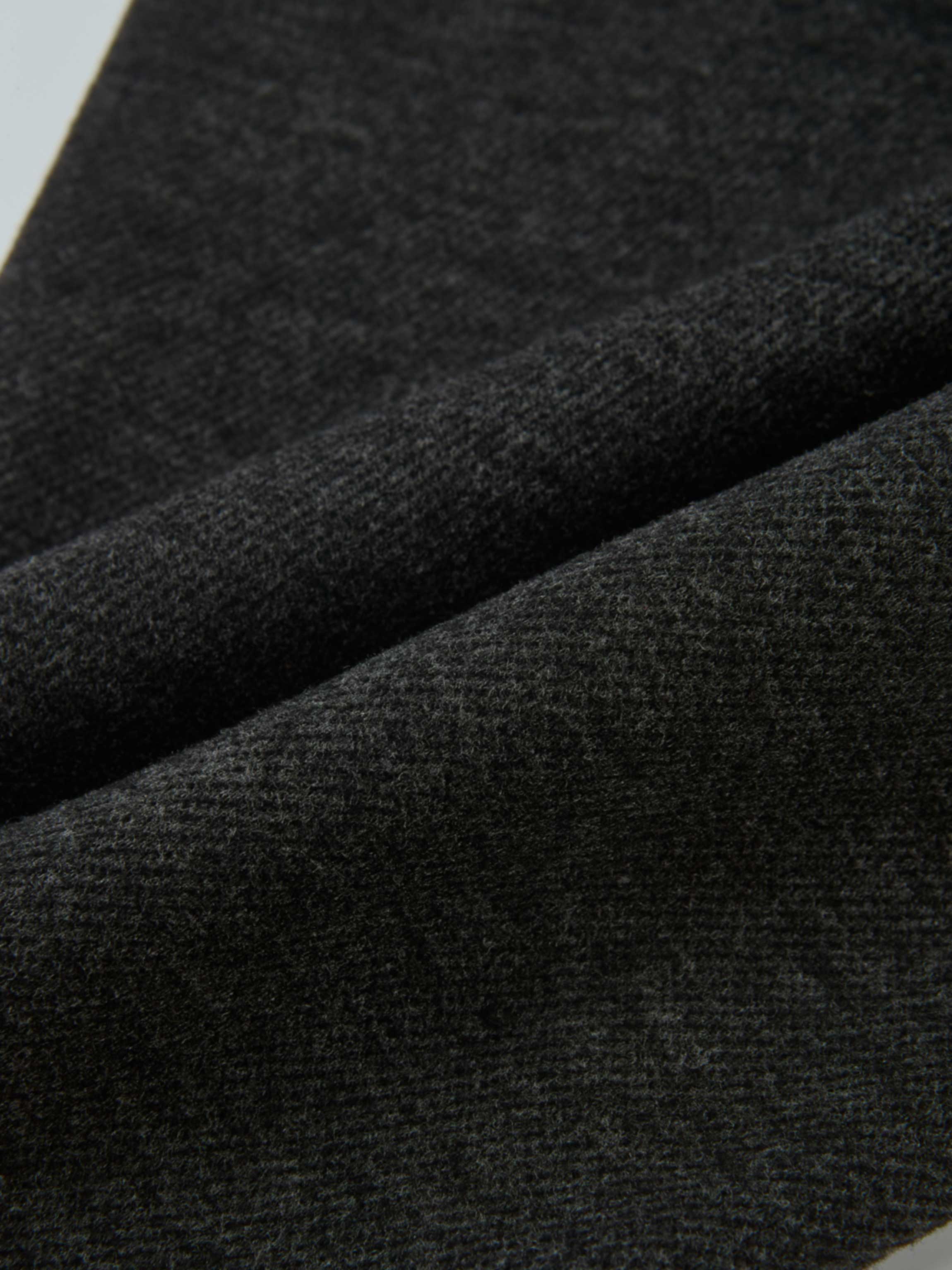 Dress pants for boys in grey; close-up of textured fabric