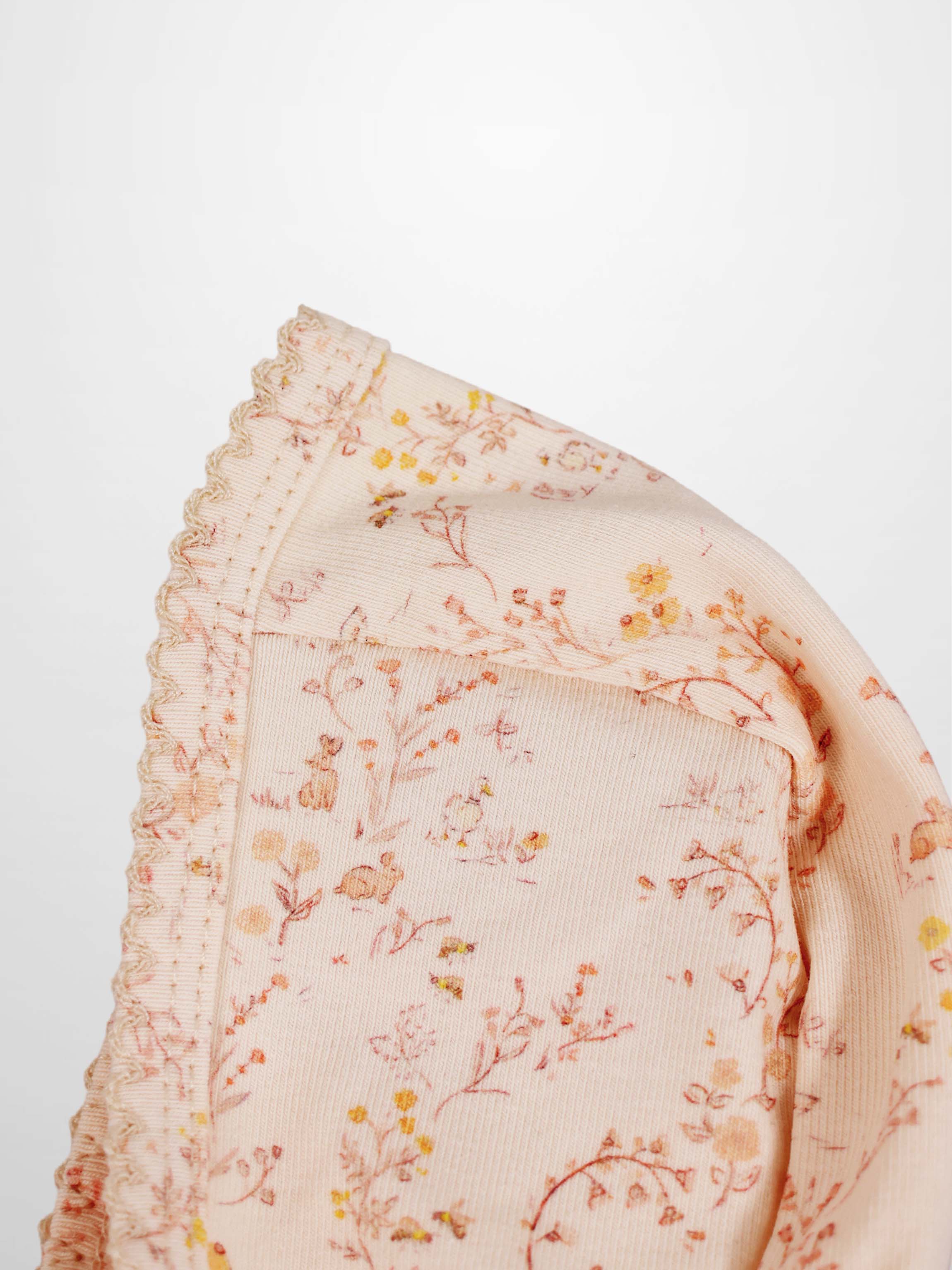 Sweet Meadow Bonnet by Adee, pink floral knit with ruffled trim.