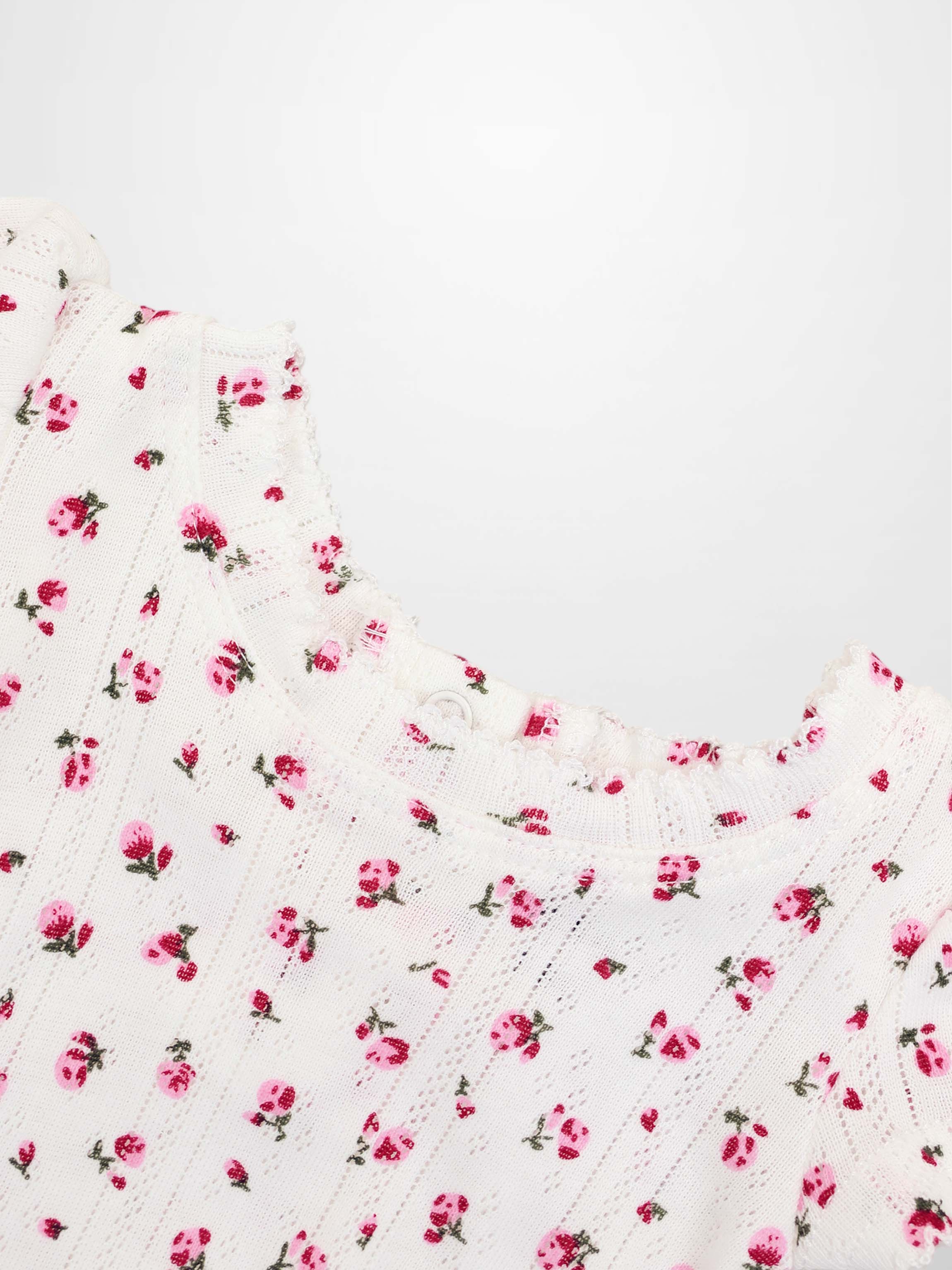 Pointelle Floral Romper for girls by Adee, white knit with pink flowers.