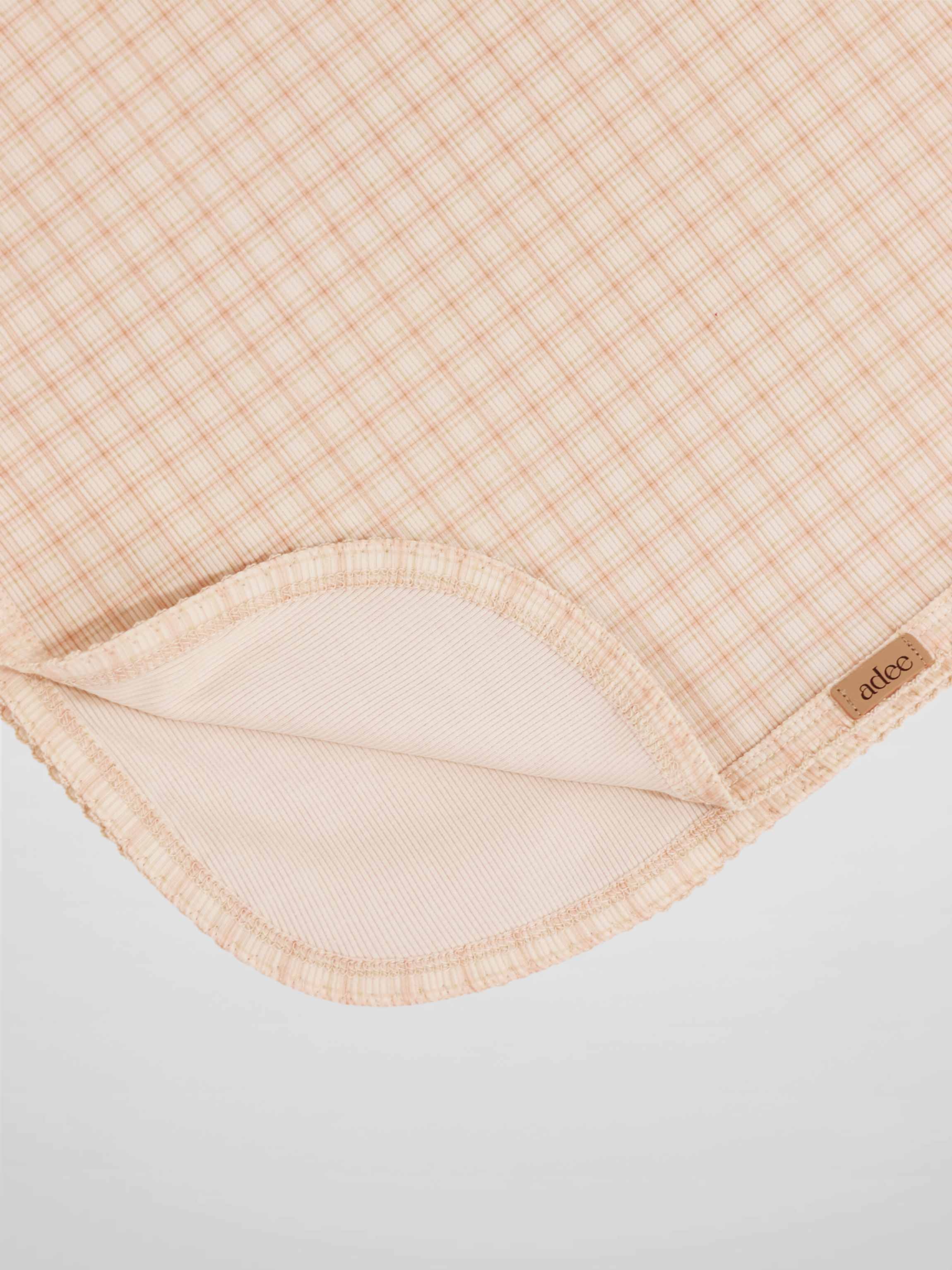 Oatmeal Grid Blanket - Pink by Adee, a girls receiving swaddle blanket with a light pink grid pattern.
