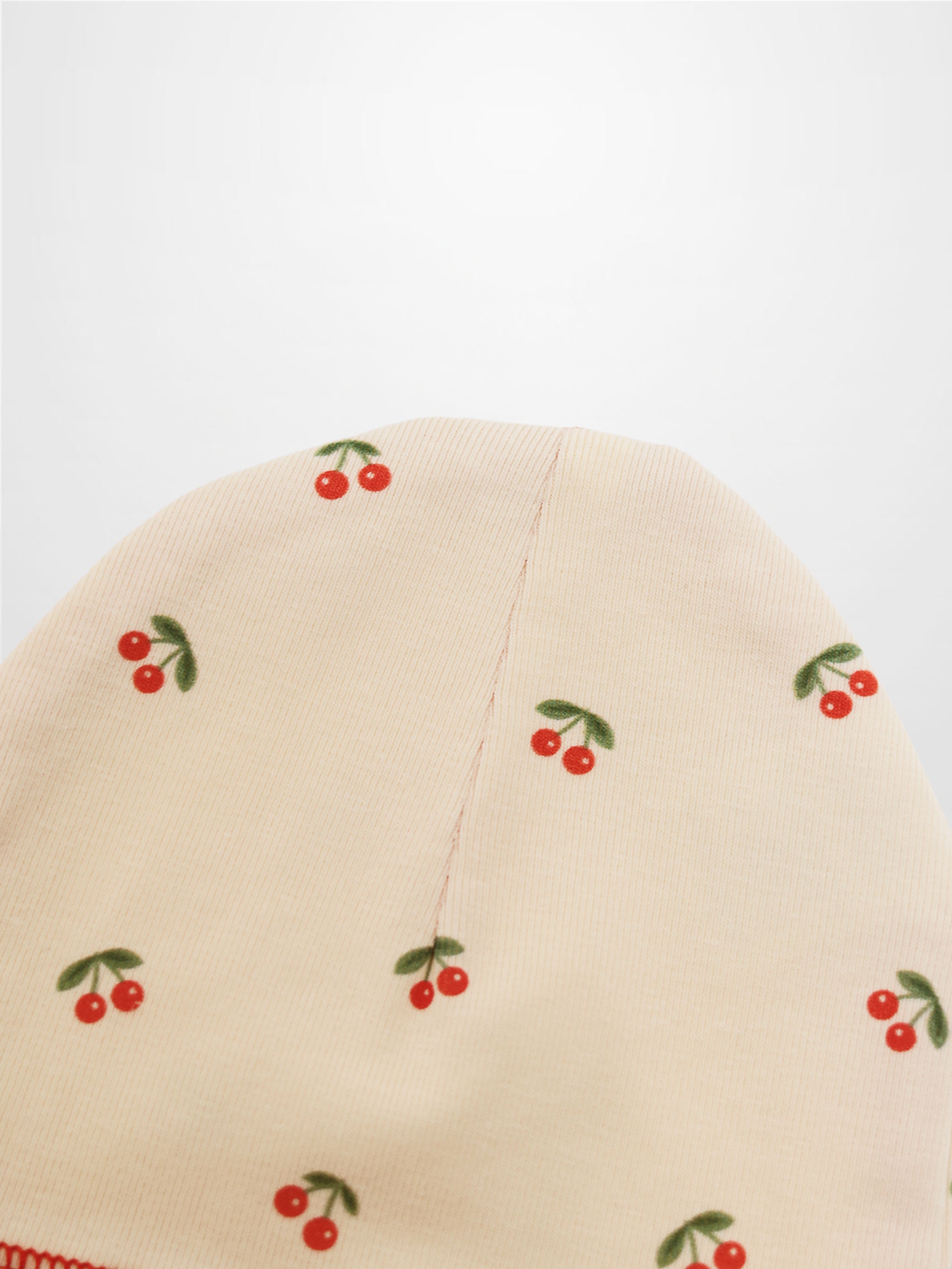 Red Cherry Hat by Adee; cream hat for girls with scattered red cherries print.