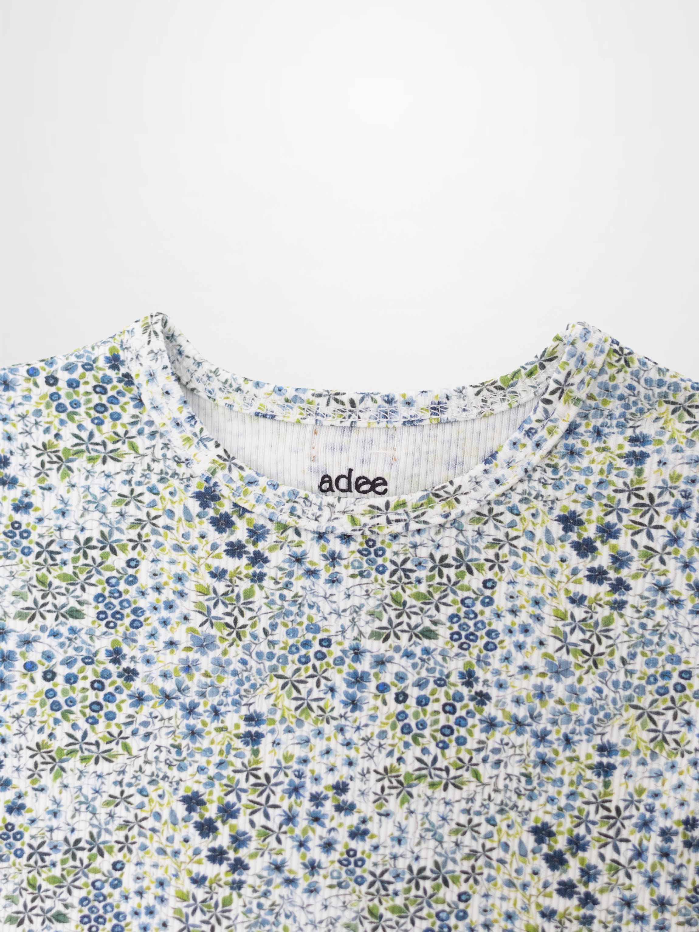 Blue floral pajama top with tiny blue, white, and green flowers.