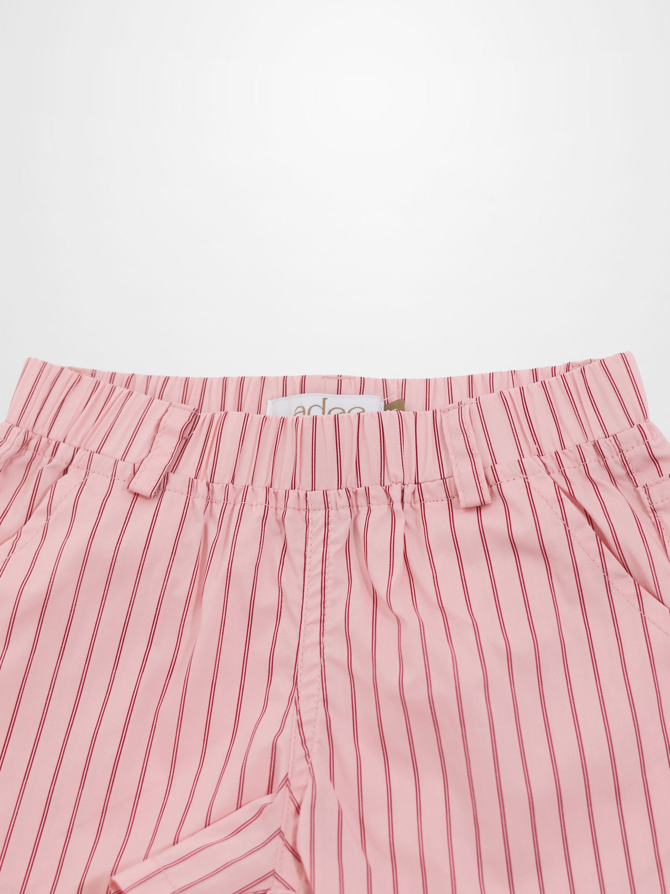 Pink cotton shorts with thin red vertical stripes, elastic waist, and belt loops.
