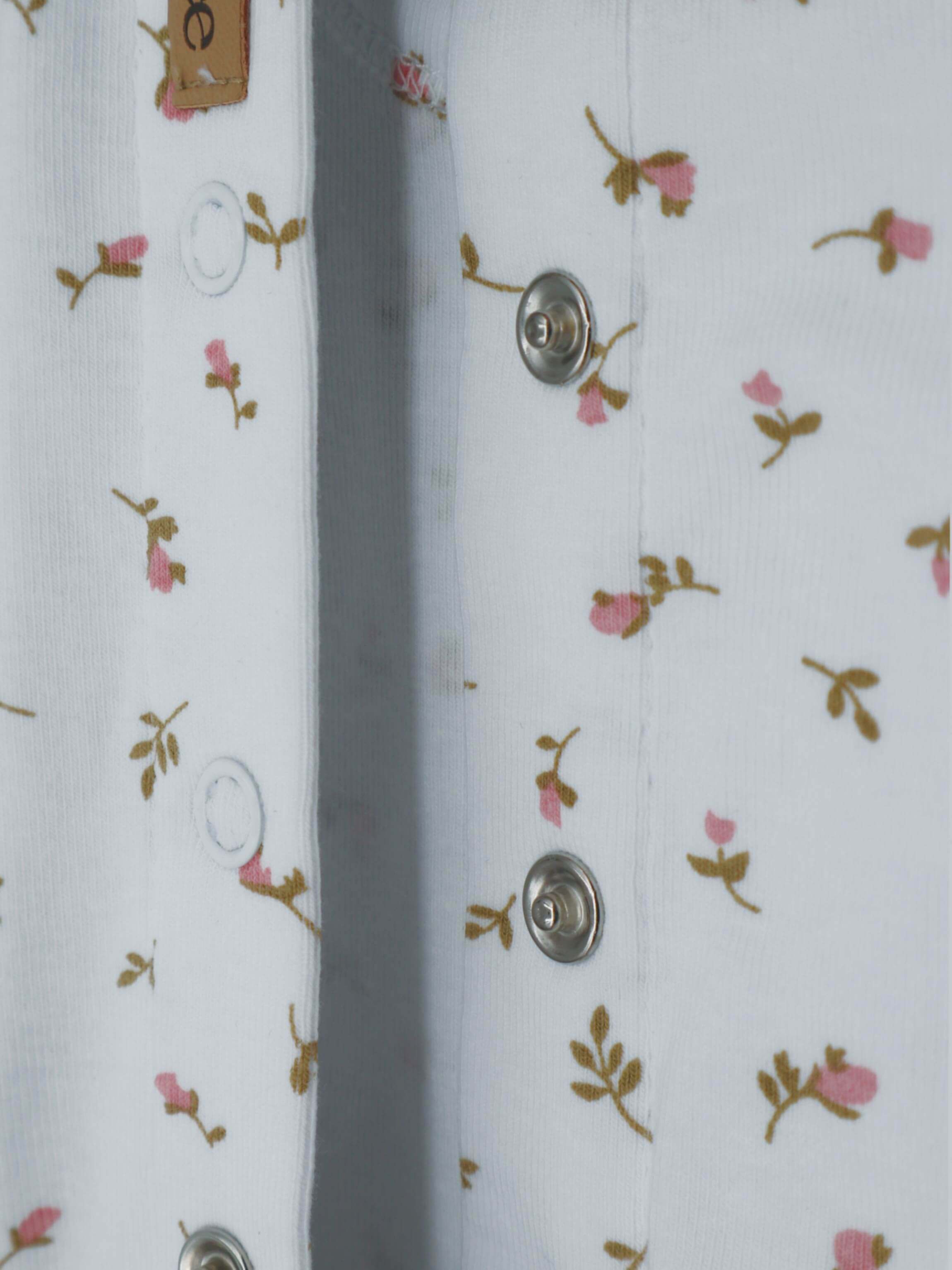 Pink jumpsuit footies with floral pattern.