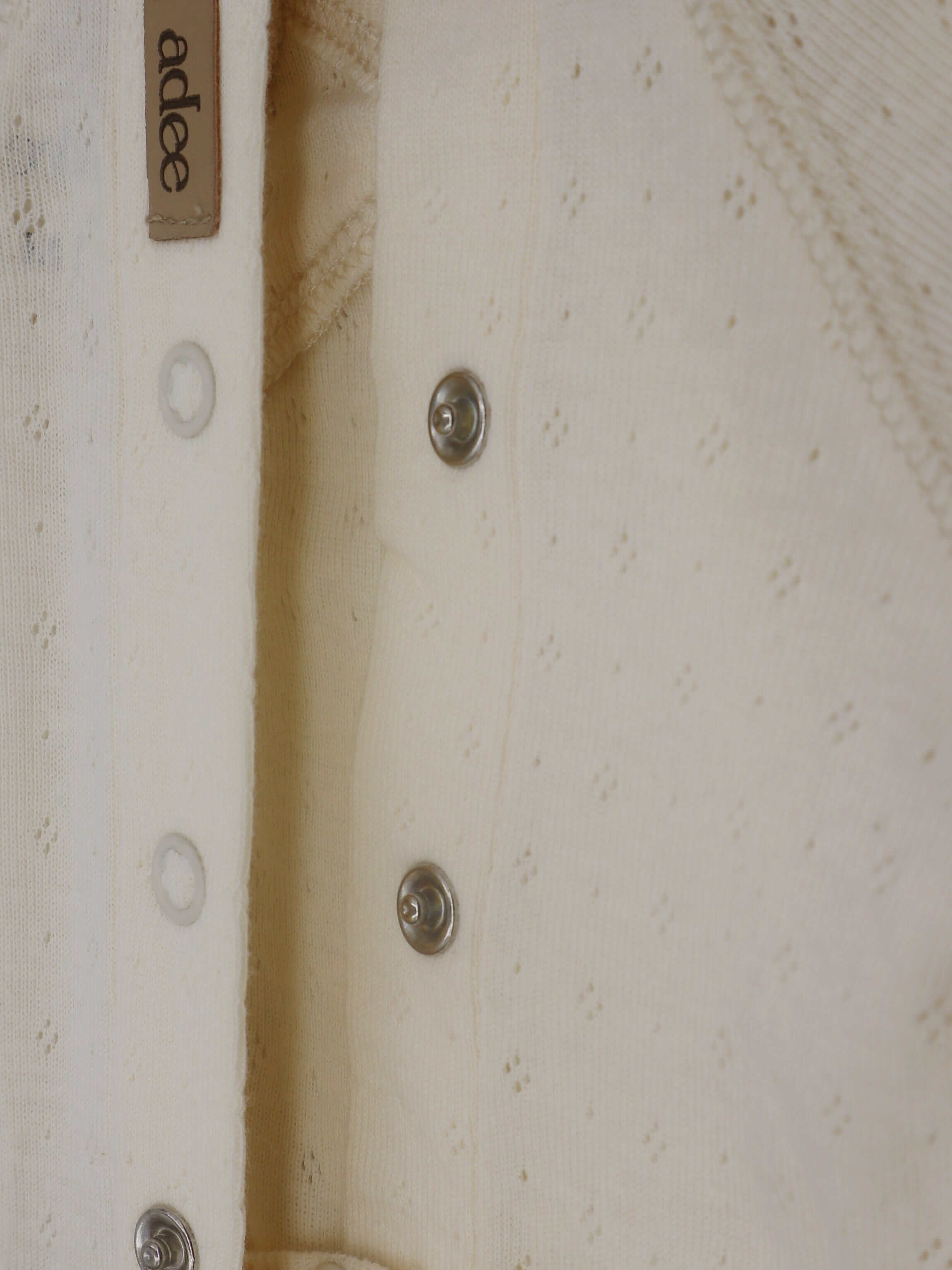 Ivory baby jumpsuit with buttons