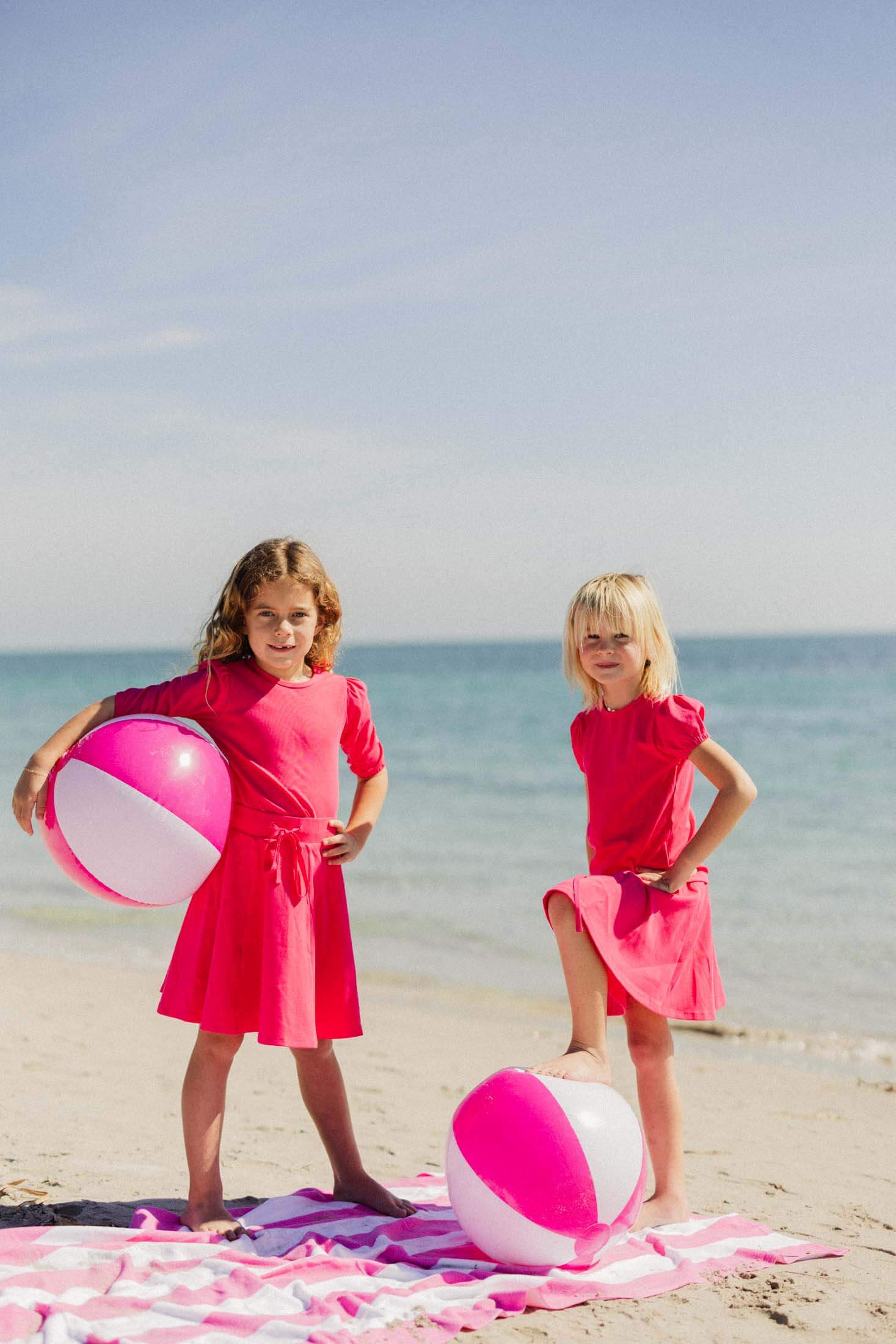 Girls in pink beach dresses