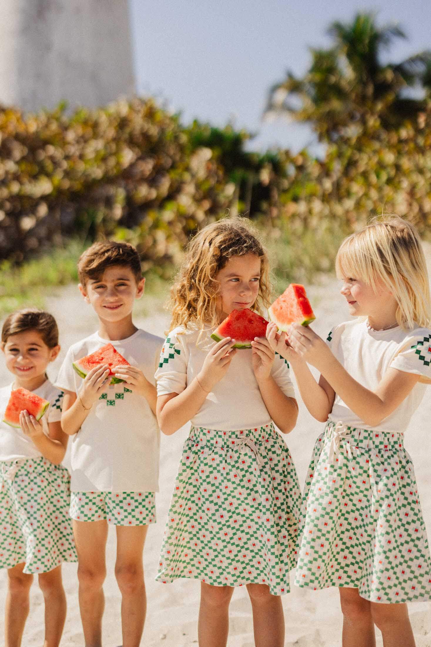 Girls enjoying watermelon, wearing skirts