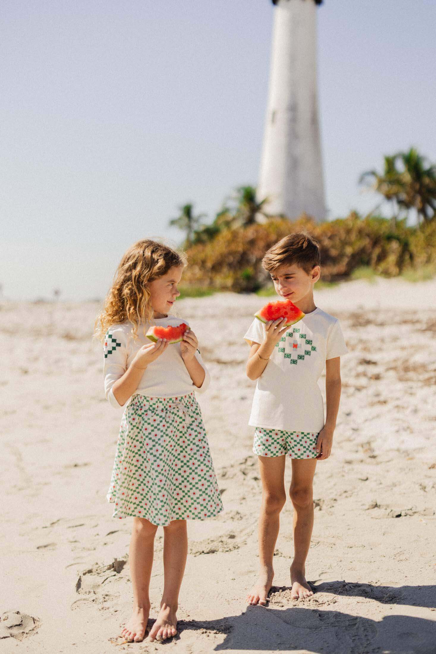 Boys and girls in diamond-patterned summer outfits