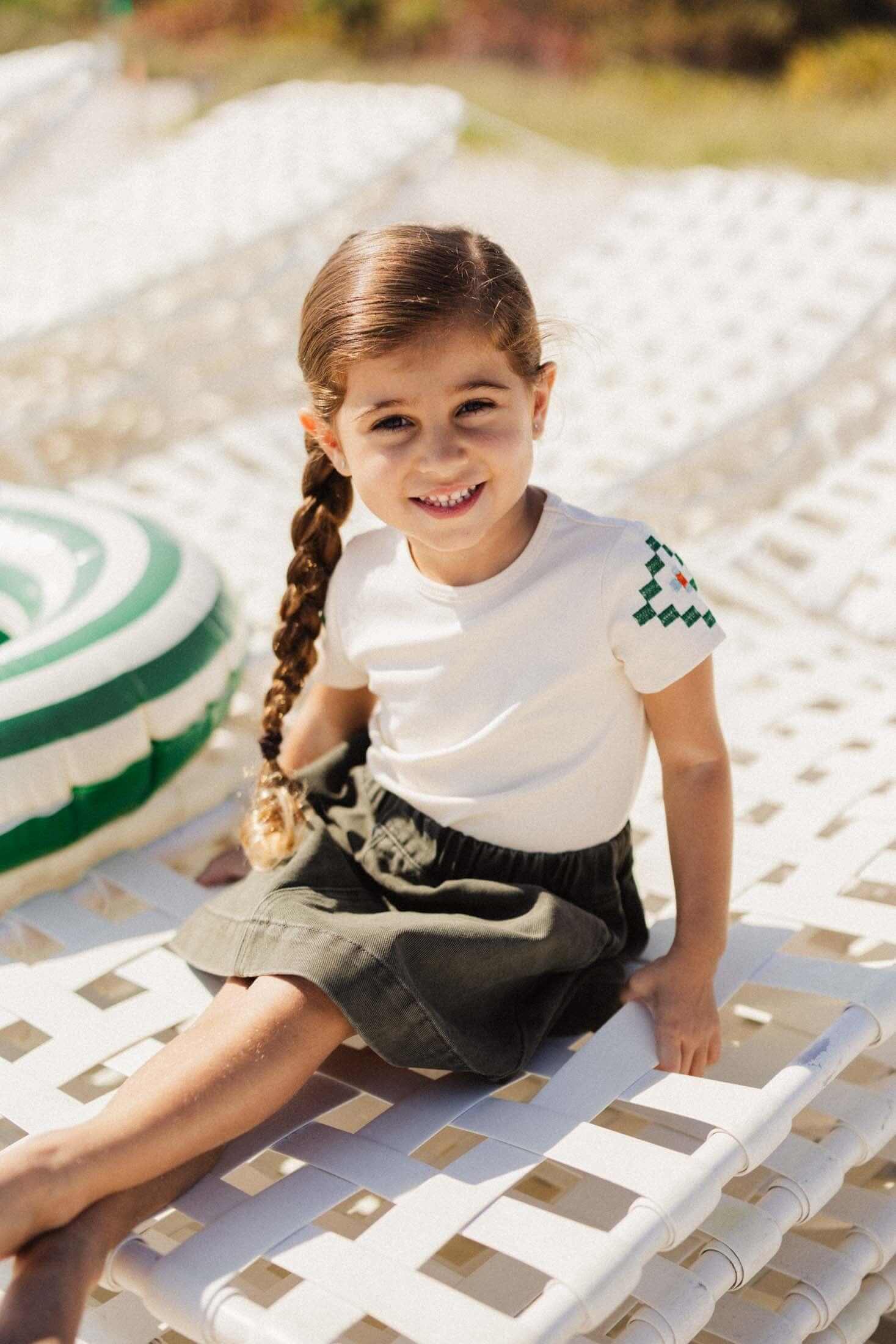 Little girl in green denim skirt