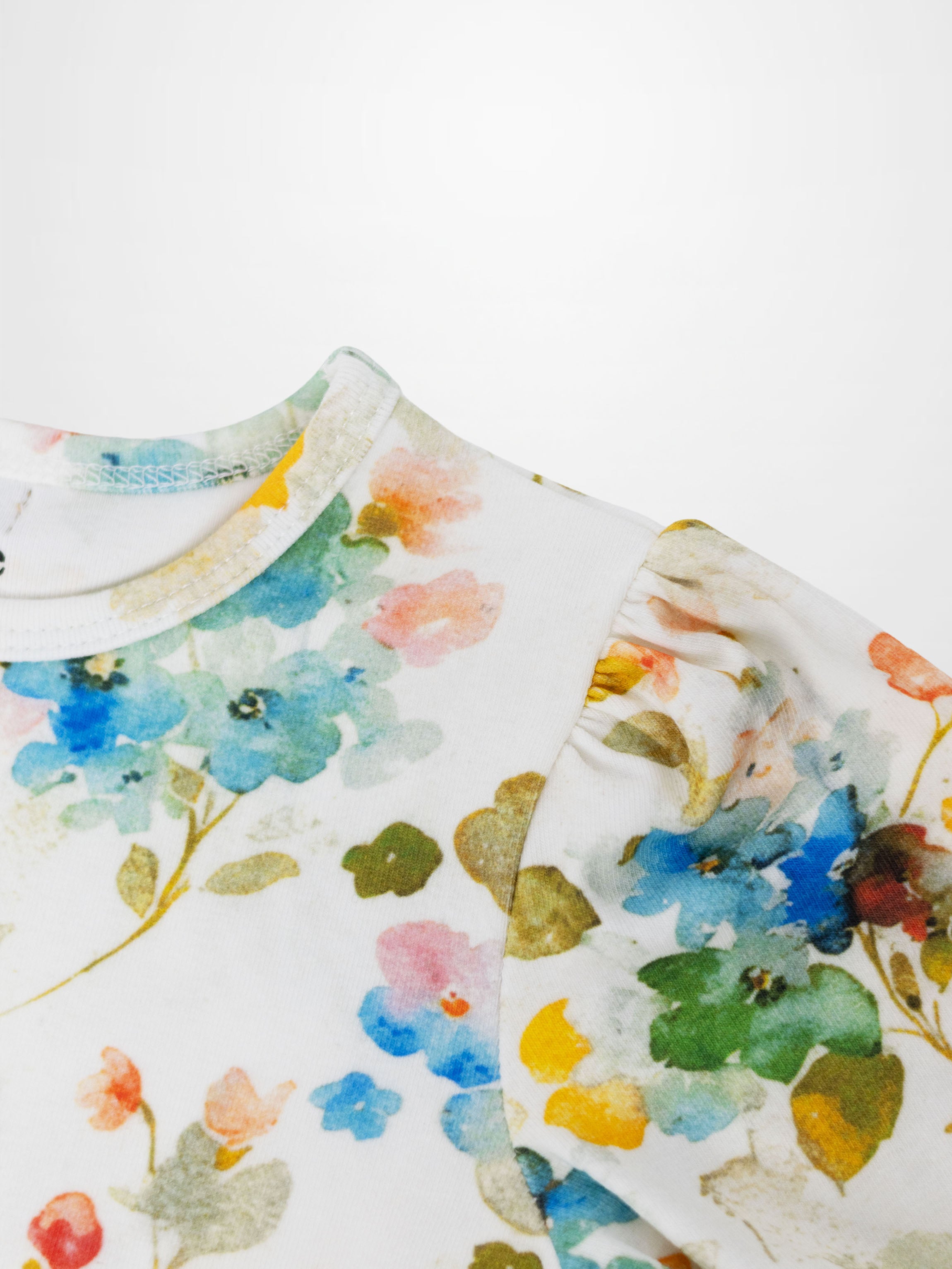 Pastel Flower Short Puff Sleeve T-shirt for girls; white fabric with pastel floral print.