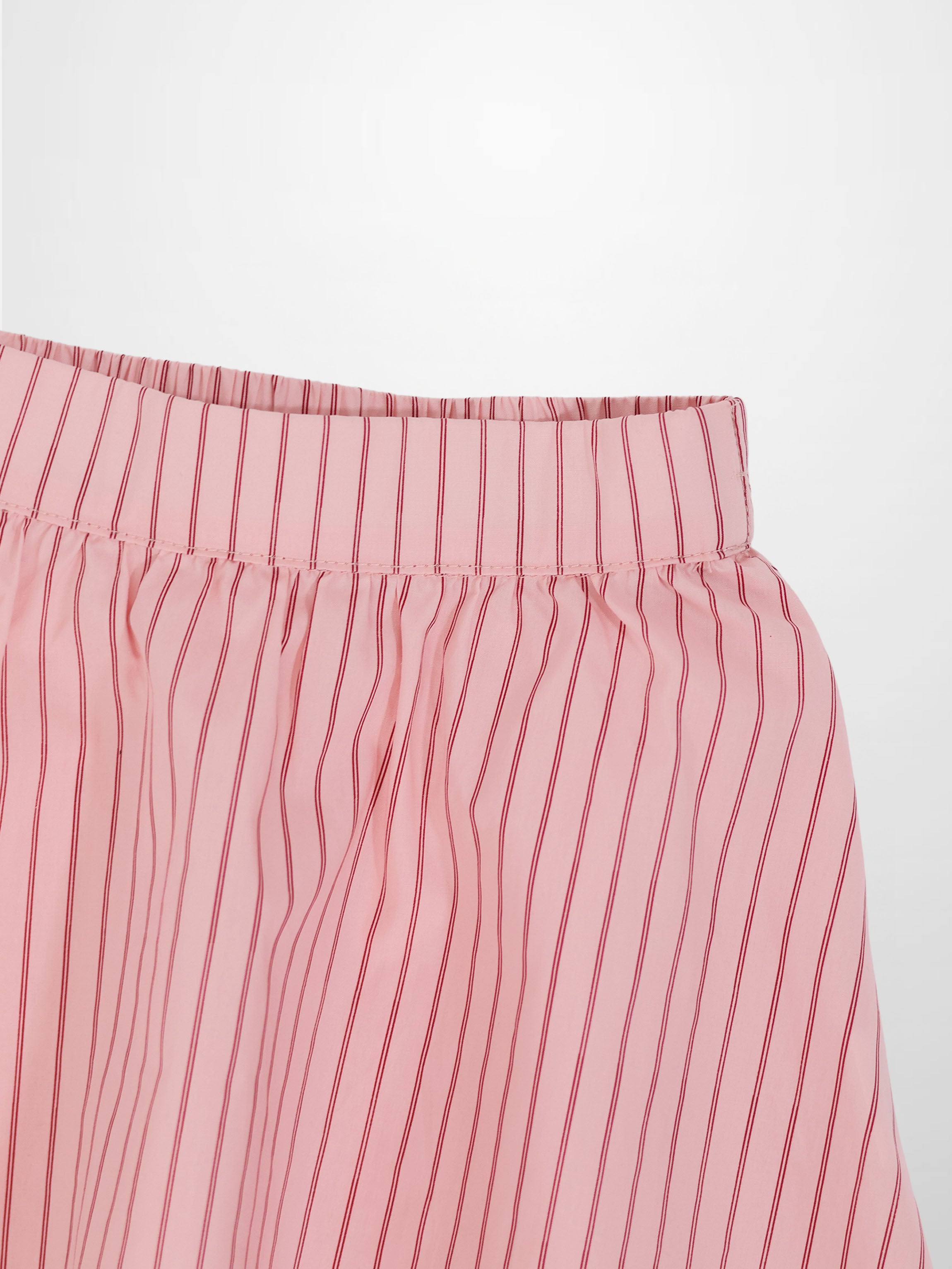 Pink striped cotton skirt with elastic waistband and vertical red stripes.