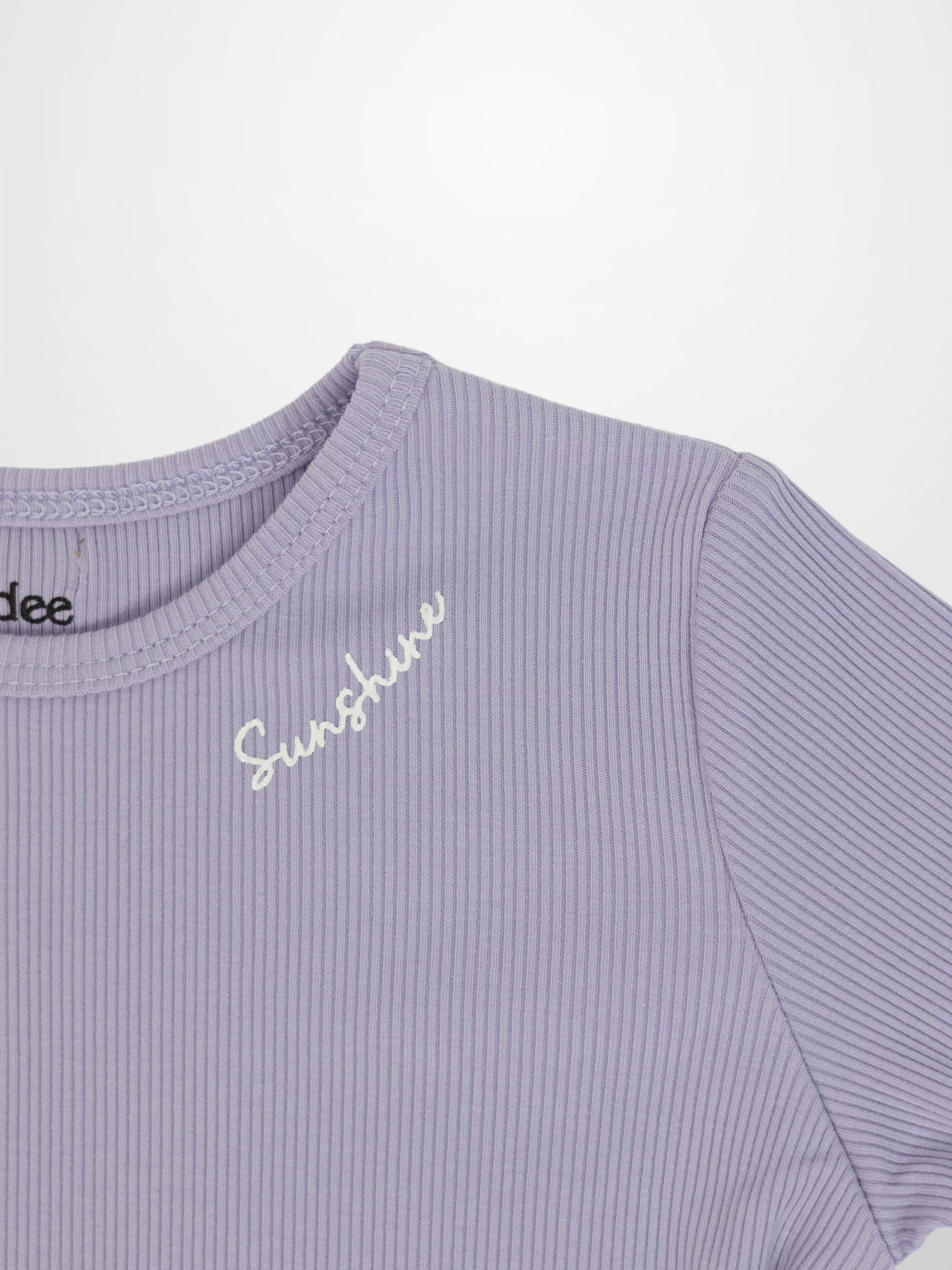 3/4 sleeve lavender T-shirt with ribbed knit fabric and white cursive embroidery.