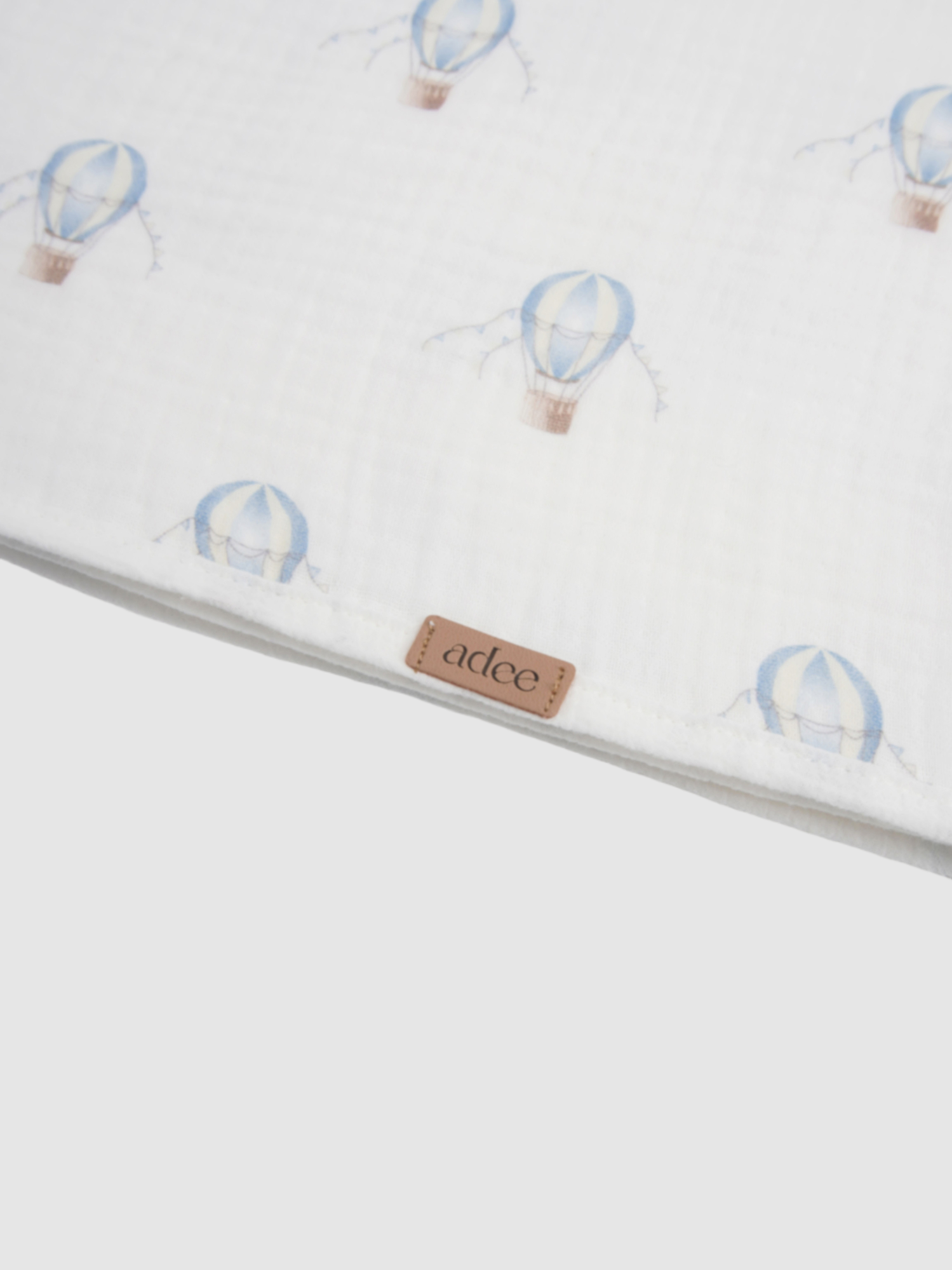 Blue balloon swaddle blanket for boys by Adee, white fabric with light blue balloon motifs