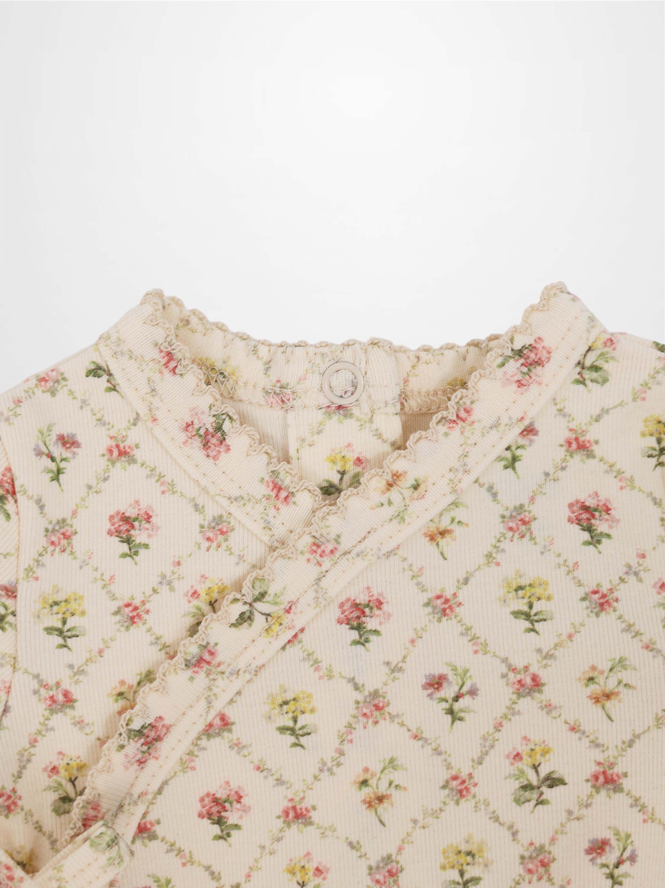 Flower Garden Stretchy Girls Stretchies cream knit with a floral lattice pattern and frilled edges