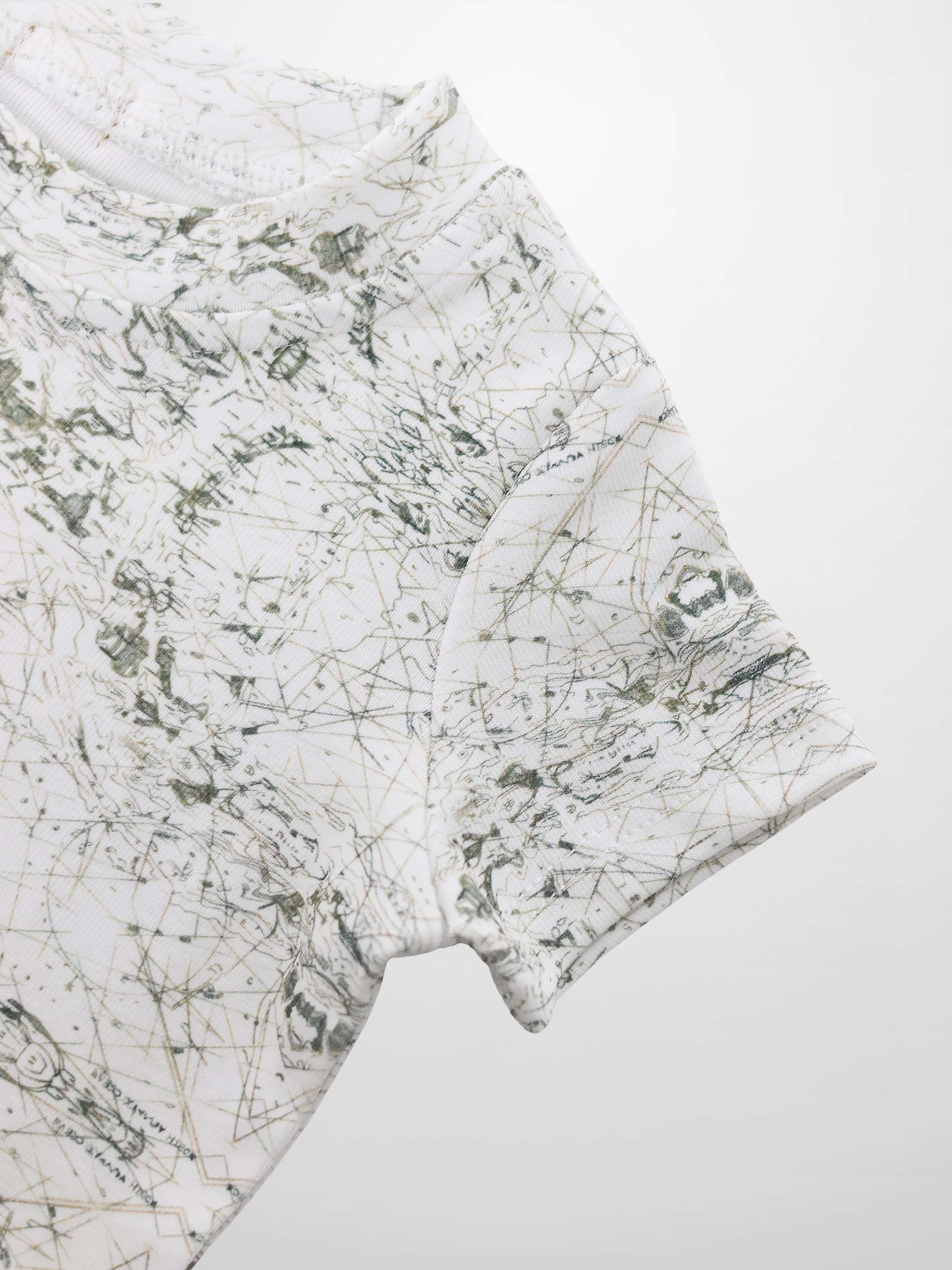 Map T-shirt with vintage sage-green map lines and compass markers on off-white fabric.