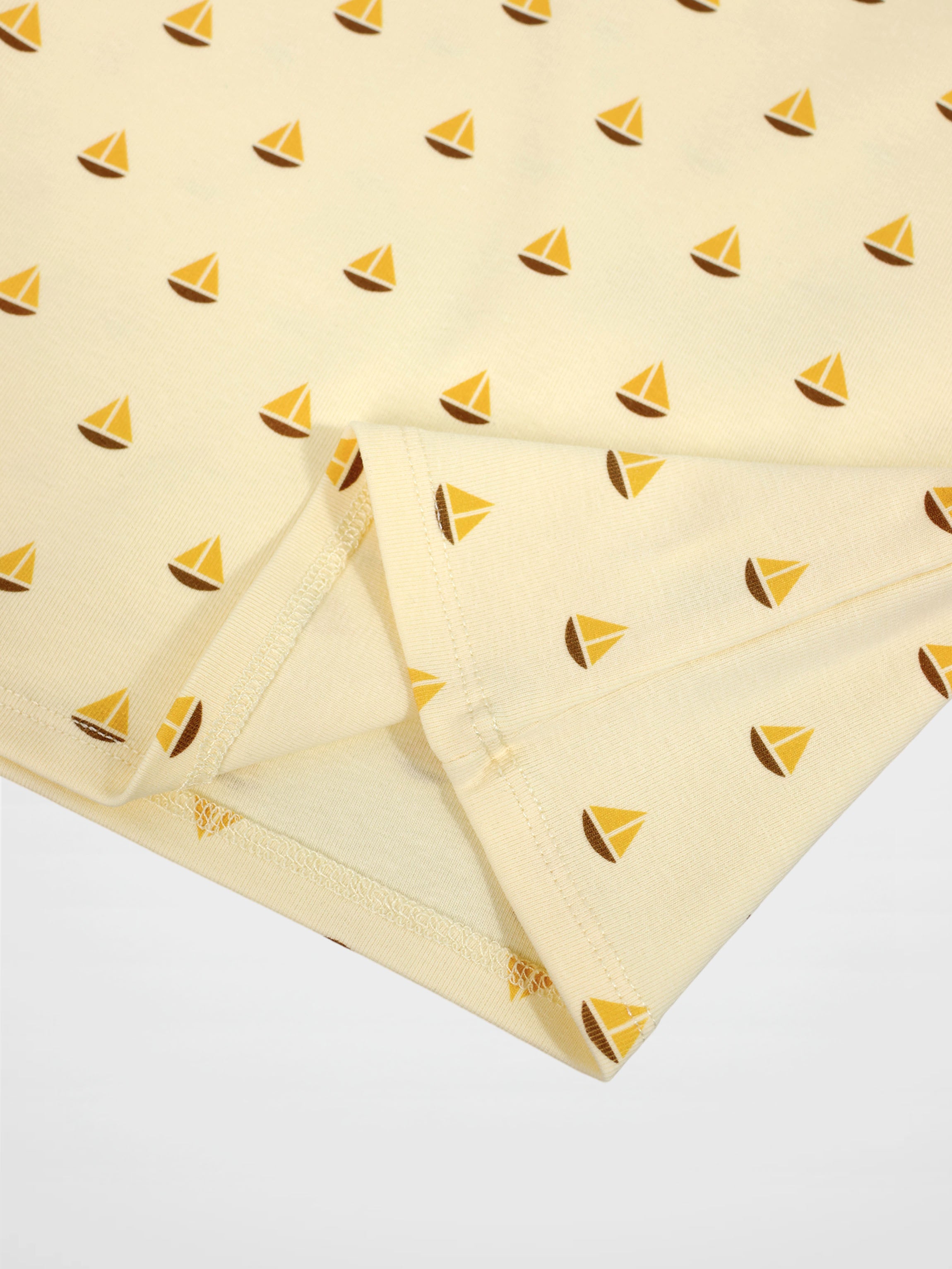 Boat Print T-Shirt fabric with small yellow sailboats on cream background.