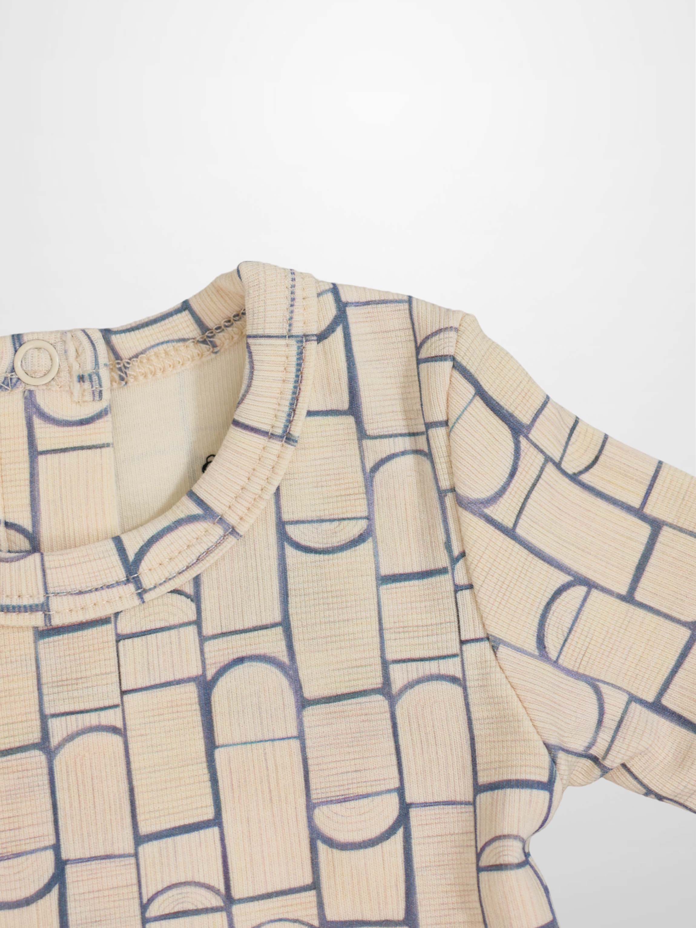 Light-beige baby jumpsuit with light-blue geometric pattern of rounded rectangles and arches, crossover front.