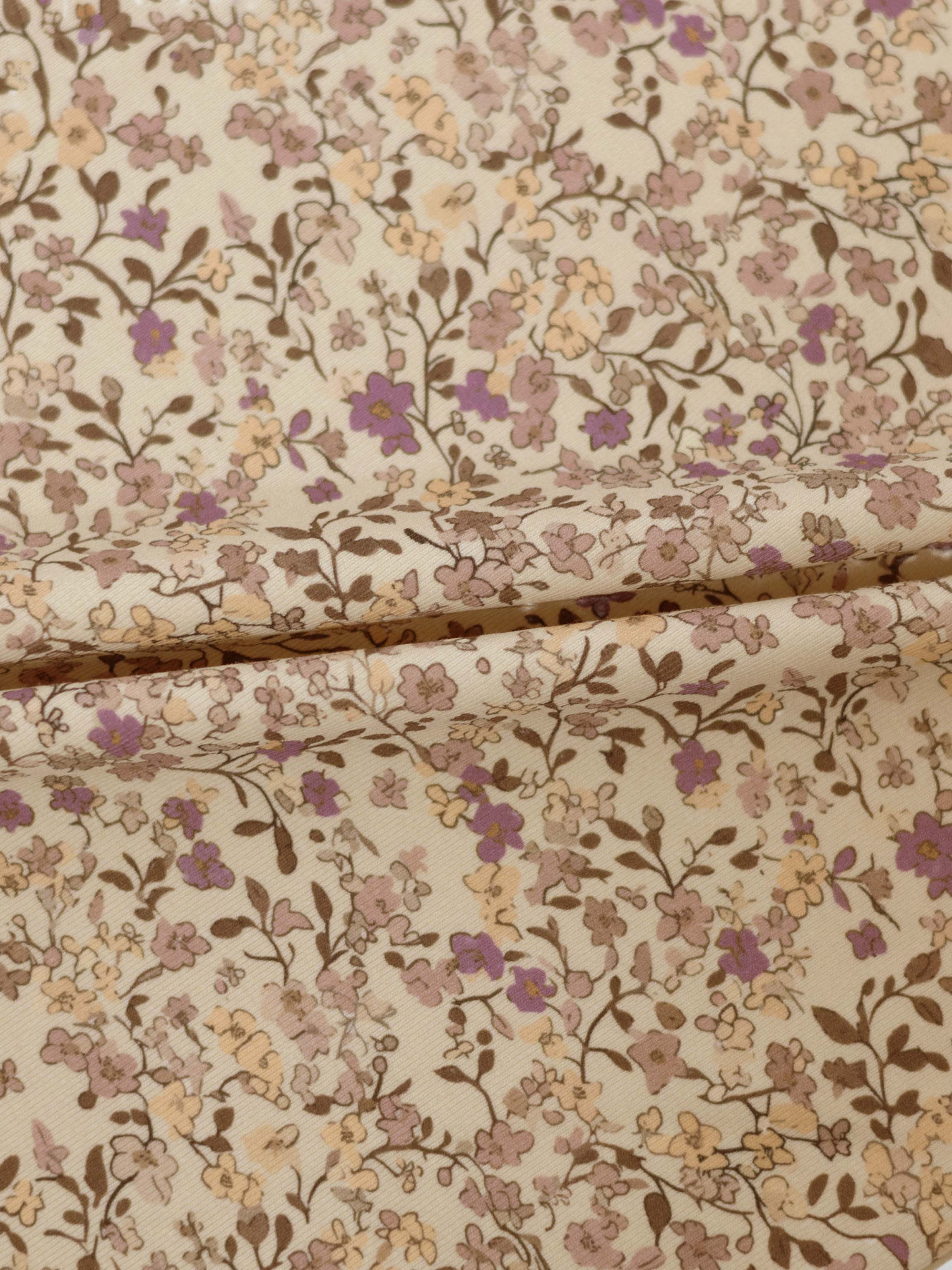 Purple Flower Skirt fabric with cream background and beige, lilac, peach floral pattern.