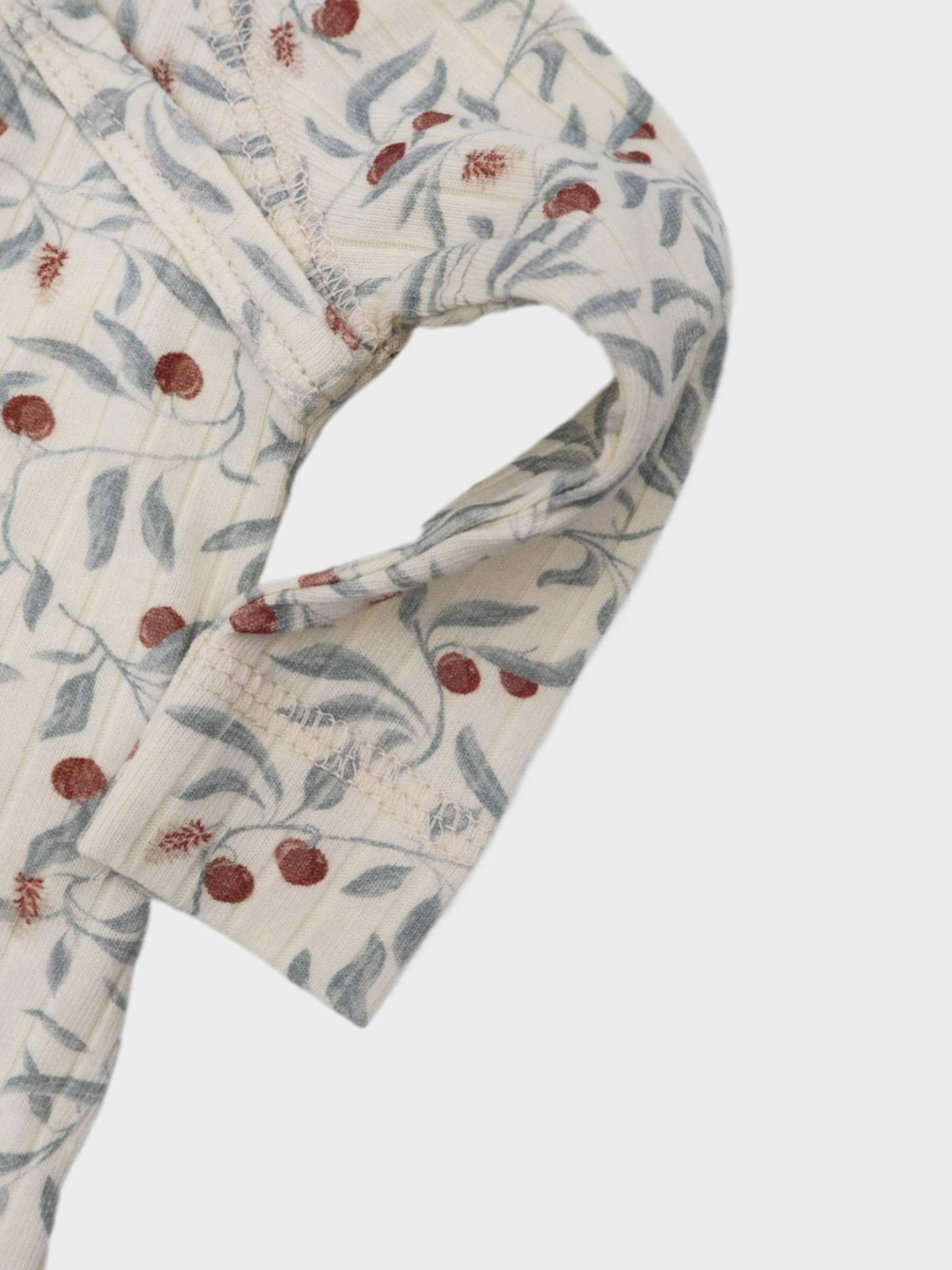 Olive Branch Stretchies by Adee; cream fabric with blue-green leaves and red berries.