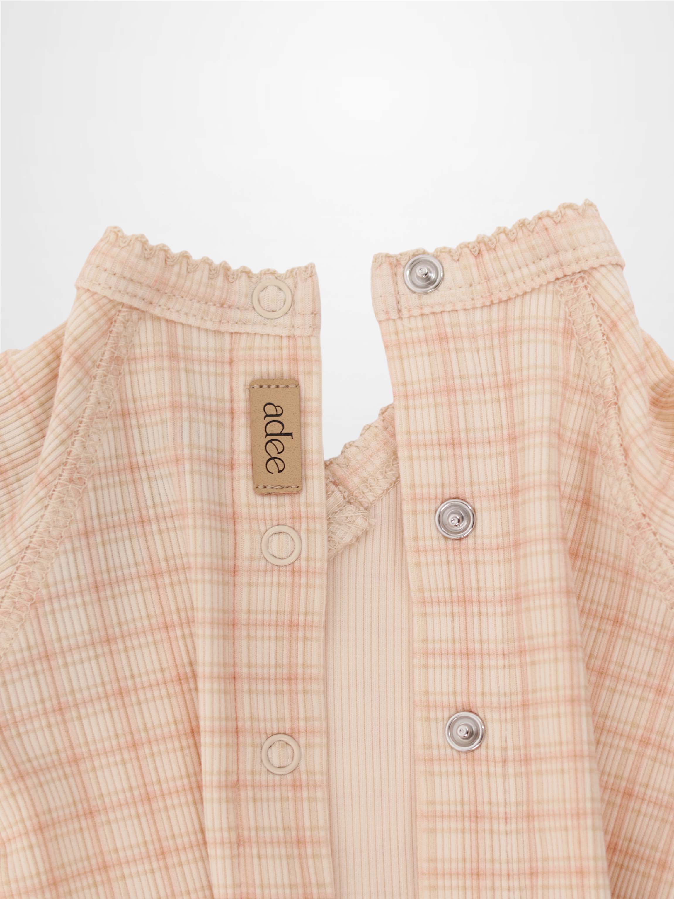 Oatmeal Grid Stretchy pink girls stretchies by Adee; plaid fabric, elastic neckline, metal snaps.