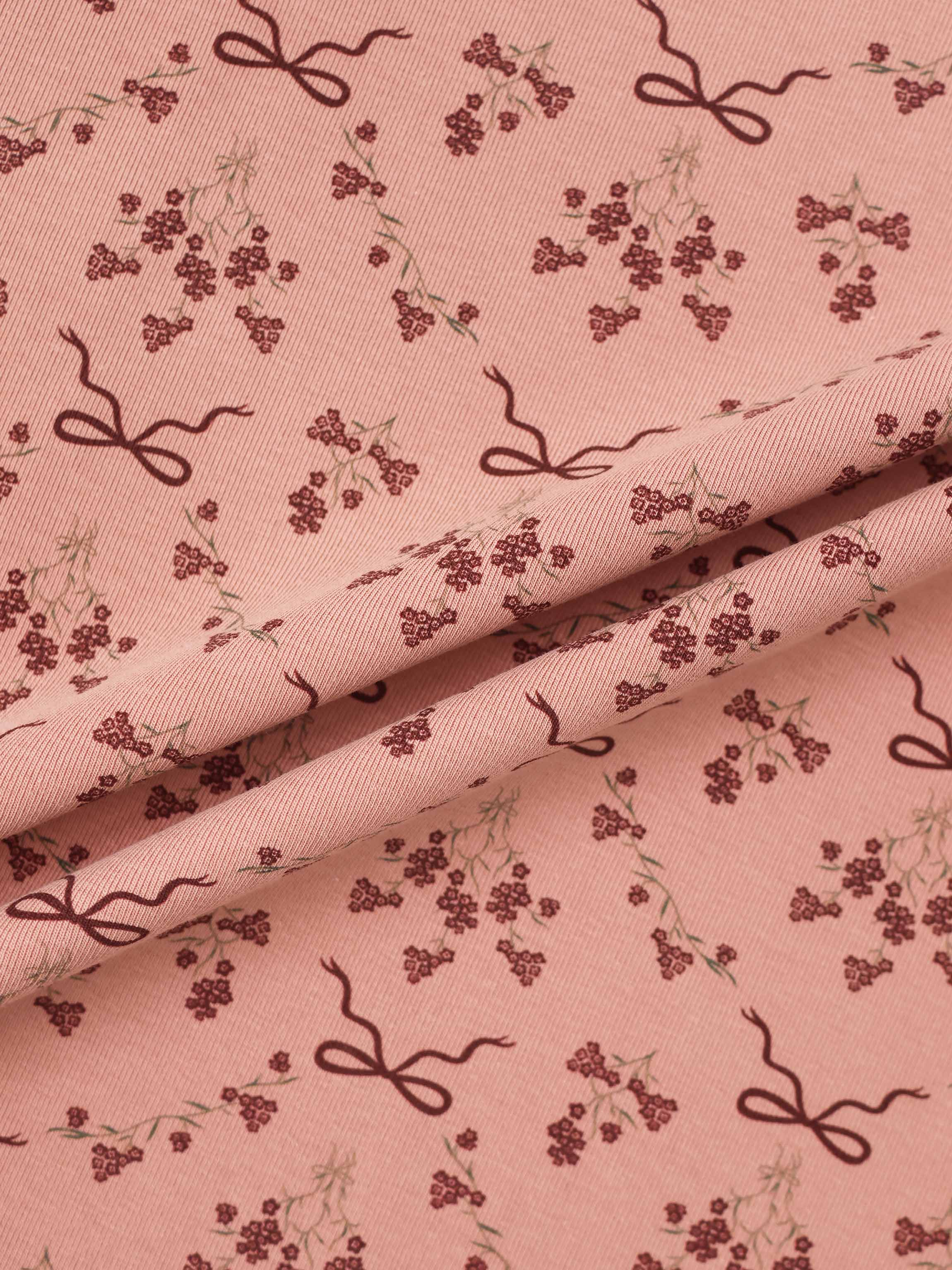 Bow Bouquet Stretchy girls stretchies fabric in pink with burgundy bows and tiny floral clusters.