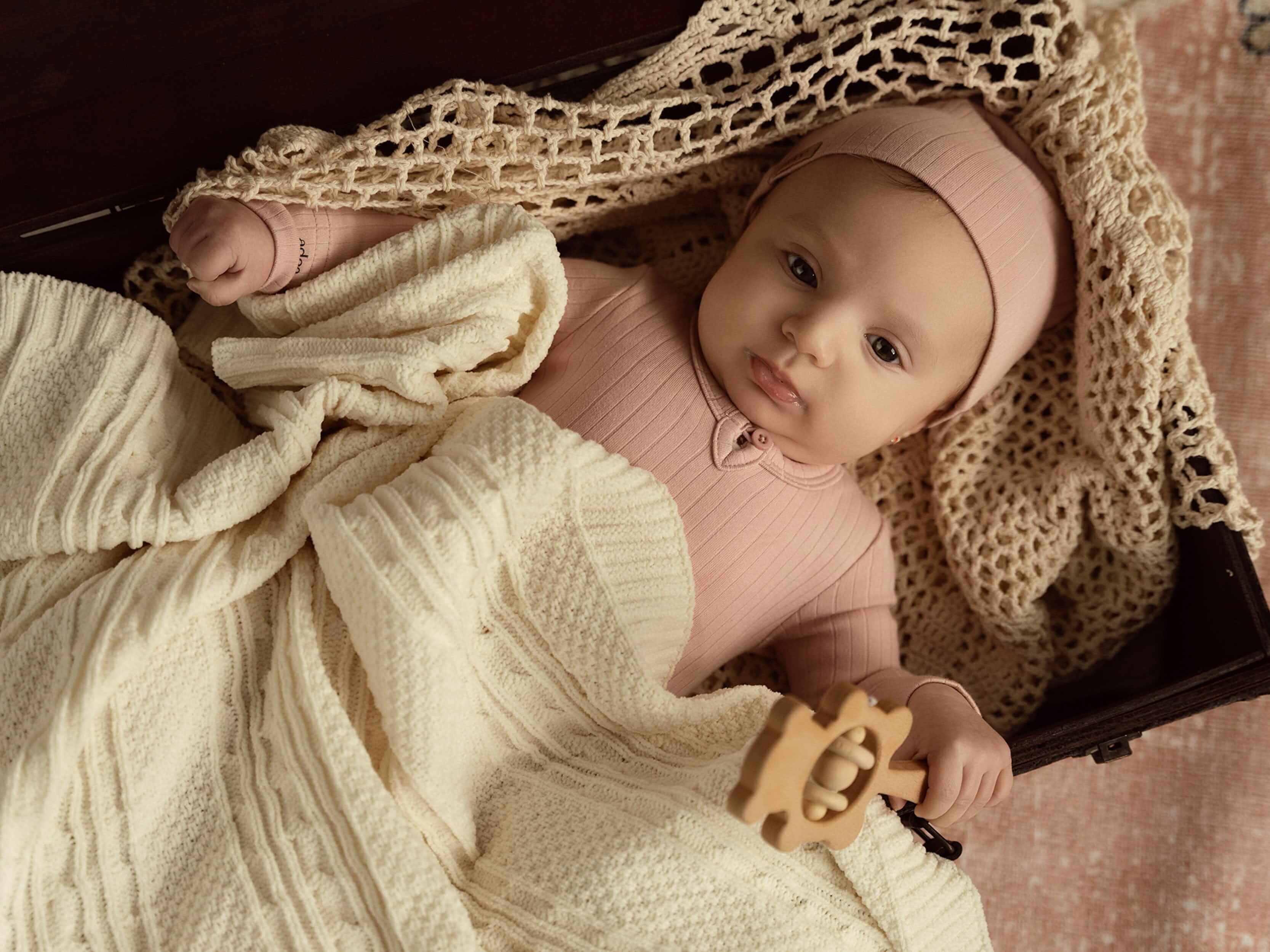 Knit baby blanket keeping a baby warm during the day